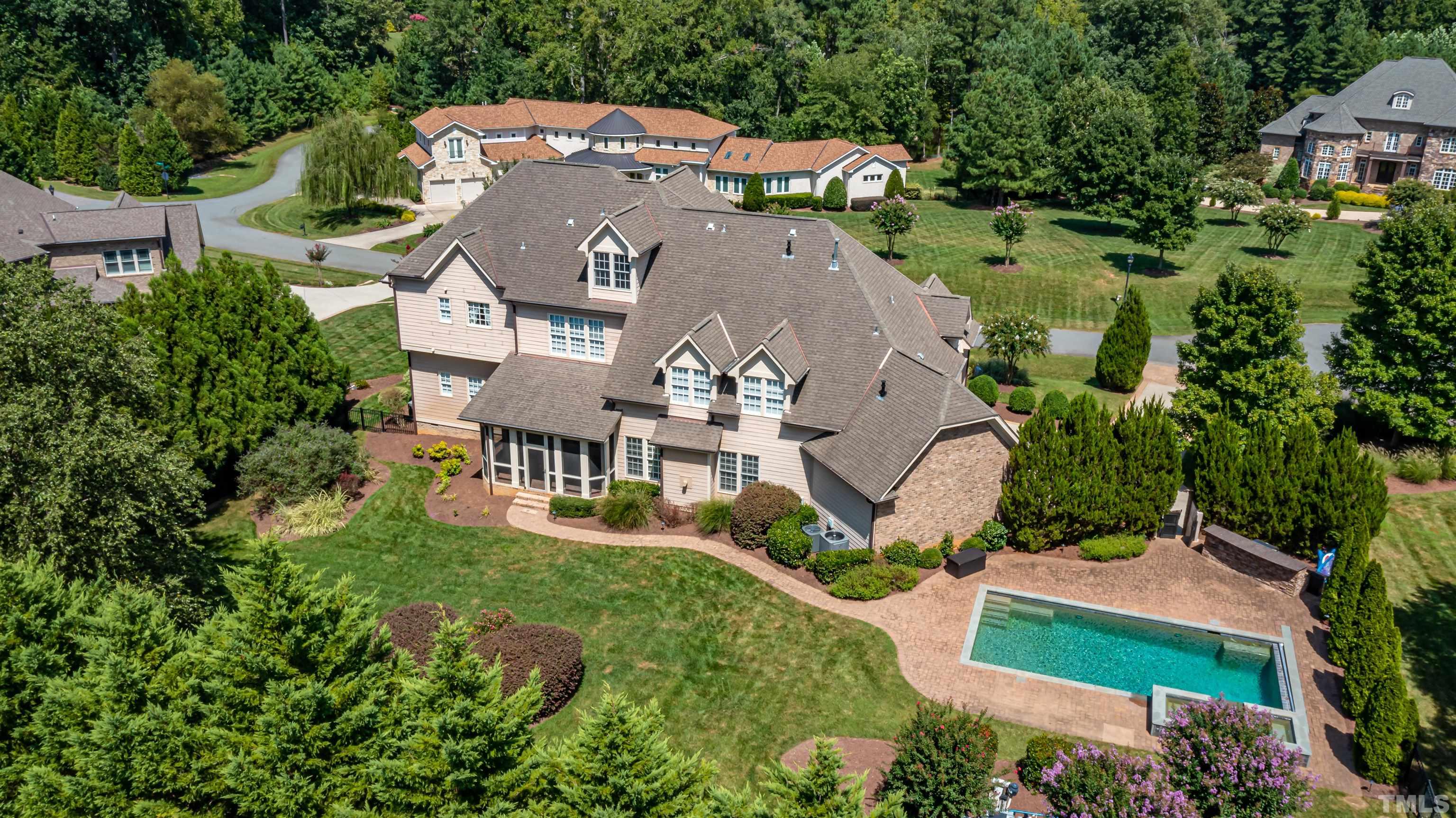 A view of the home from the rear above...nestled amongst homes of similar caliber in a private gated community.