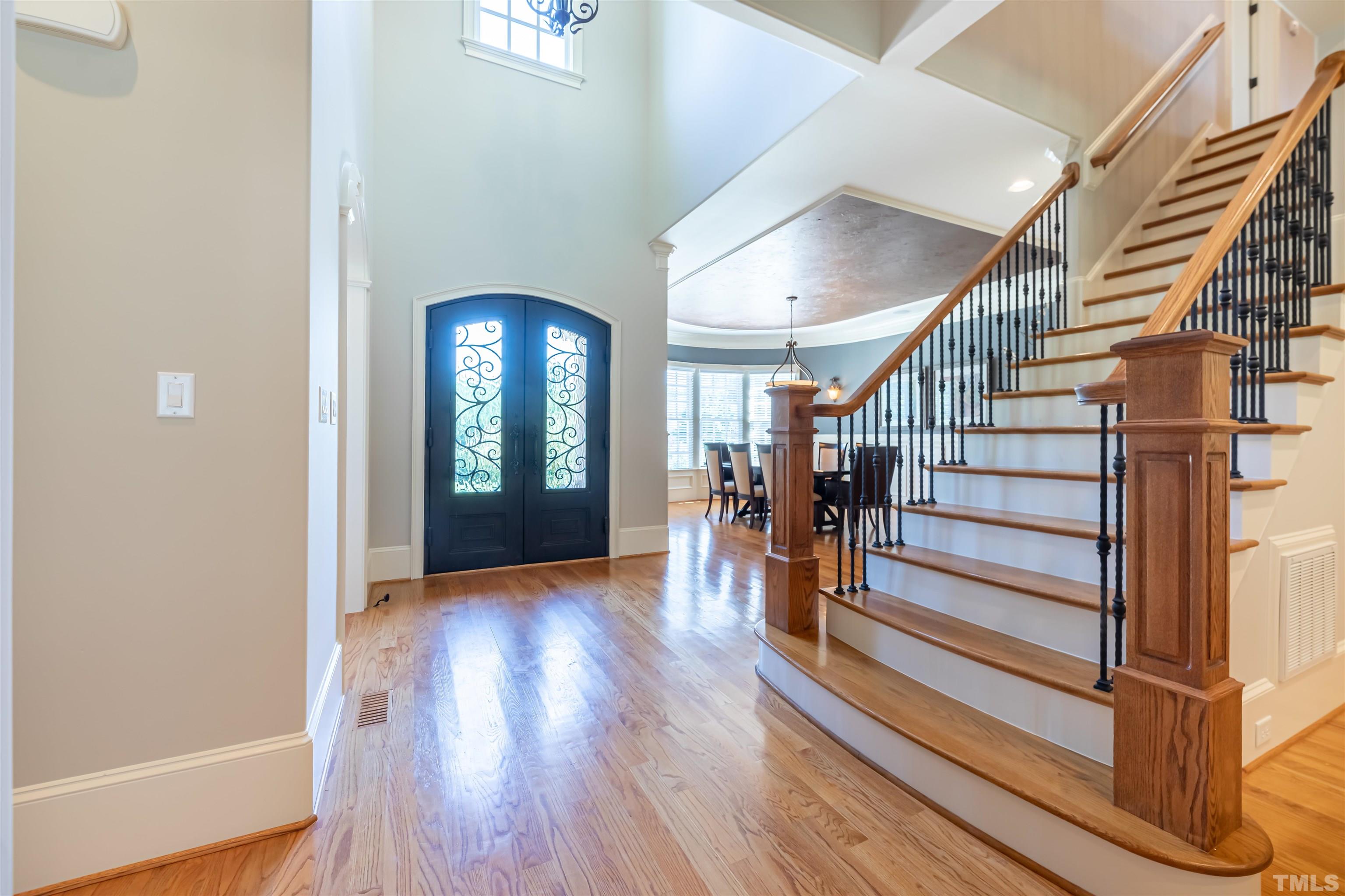 Enter the iron, double front door into the grand foyer with soaring ceilings.  Hardwoods grace the main floor living (except the guest room, bath & laundry).  The staircase is extra wide & has ornamental metal pickets.  The home has been freshly painted.