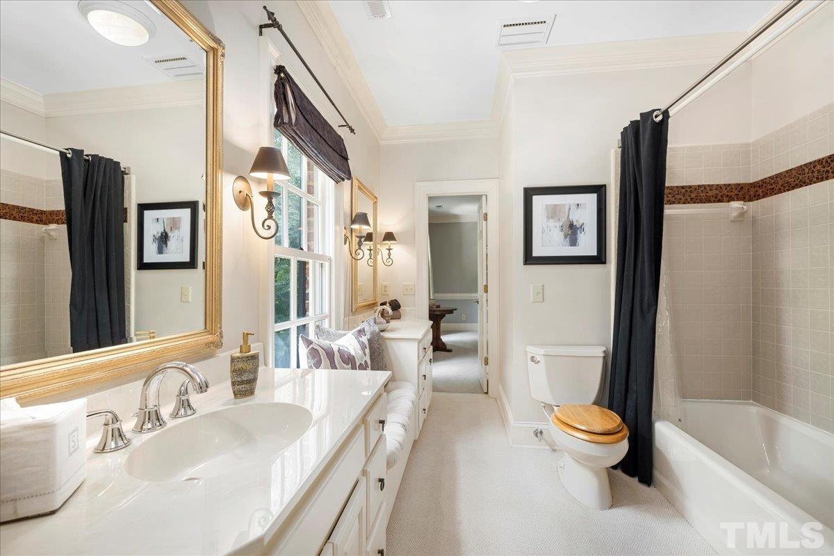 Jack n Jill bath with adorable window seat and linen closet.