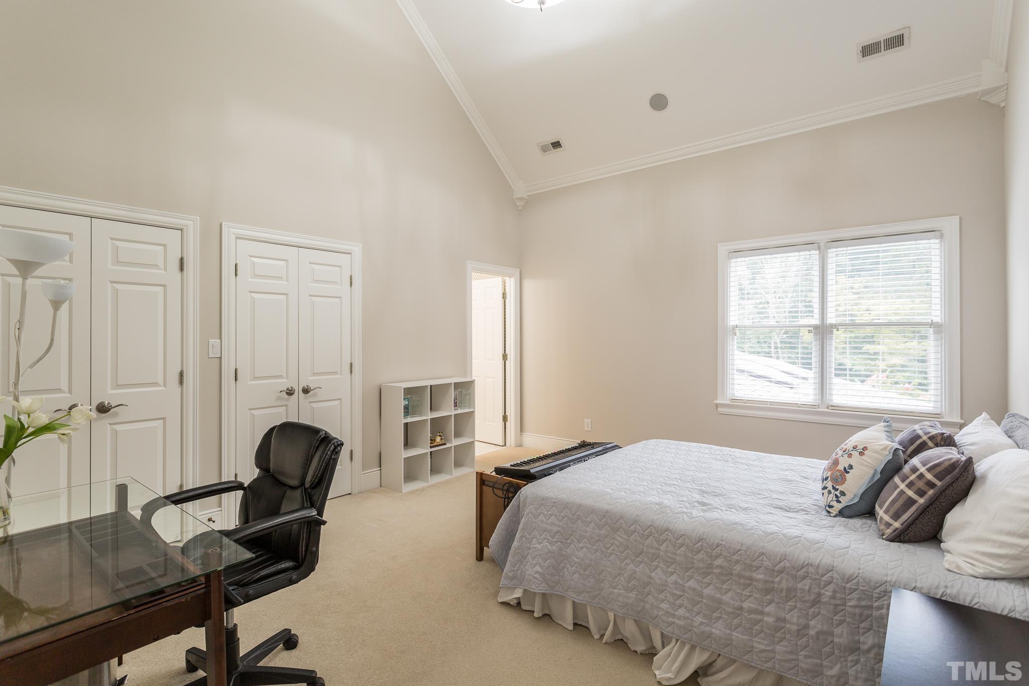 This bedroom enjoys an ensuite bath, a cathedral ceiling, and 2 double door closets.