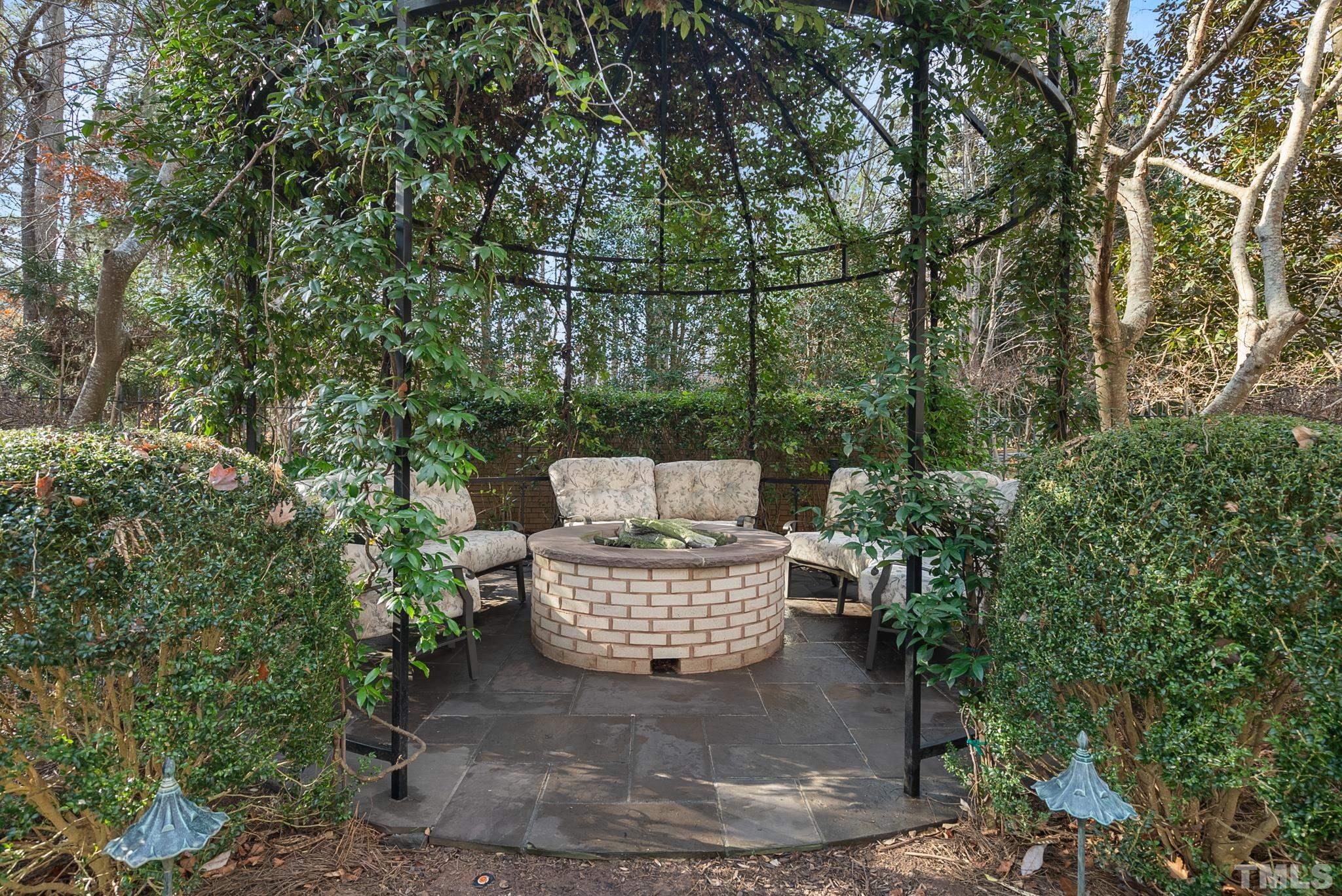 Garden in the backyard with gas fire pit.