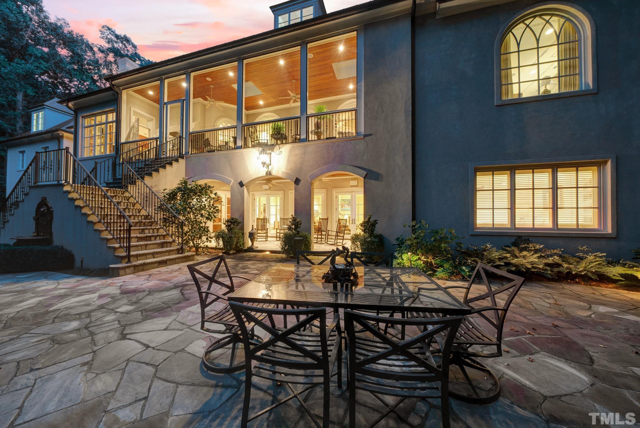 Stone patio overlooking beautiful waterfall. Entertain under covered porch area, with entrance to bar, theater room, and in law or nanny suite.