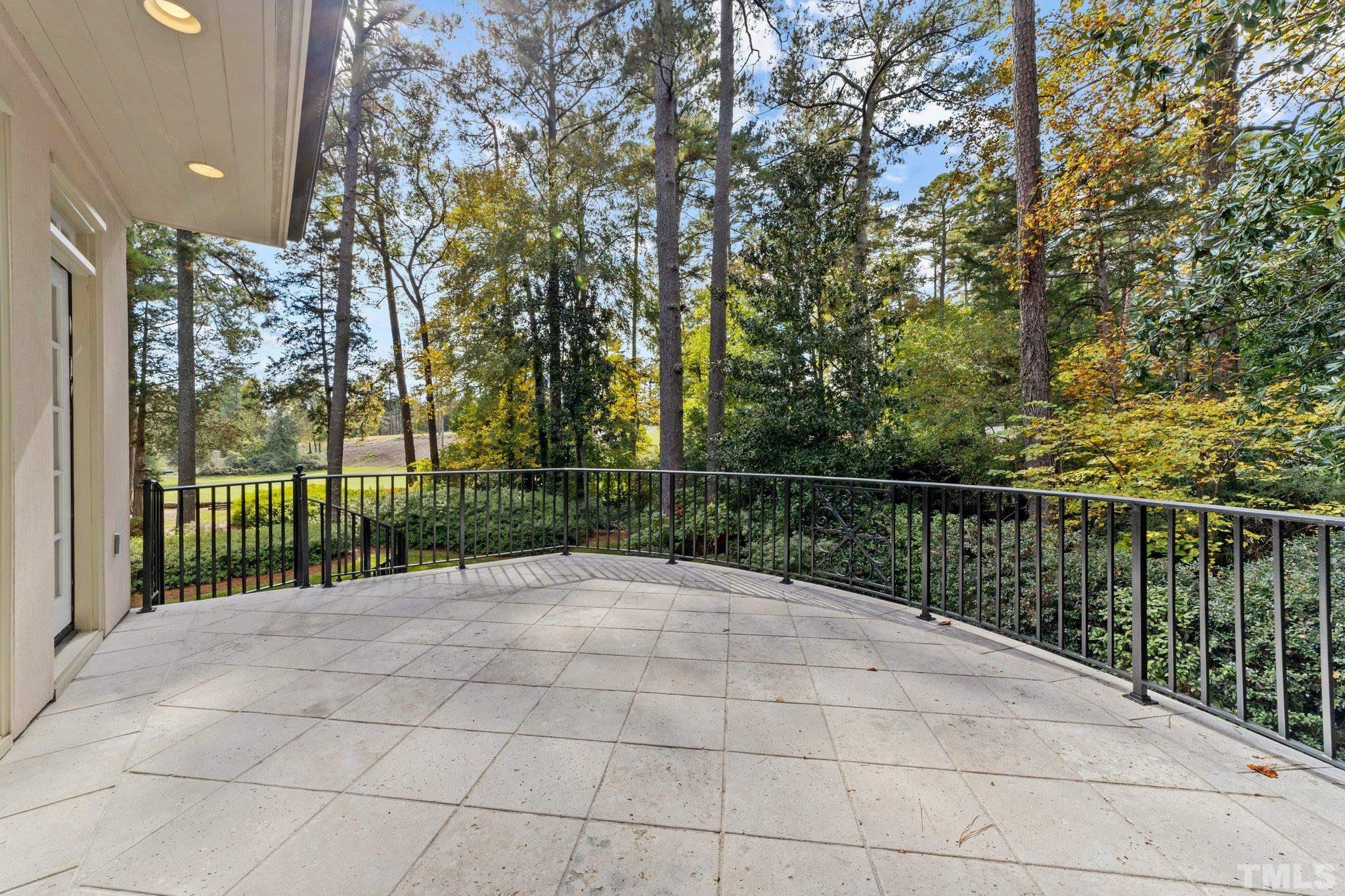 Large terrace just steps from the formal LR and paneled library offers gorgeous views of the golf fairway and sweeping landscape.
