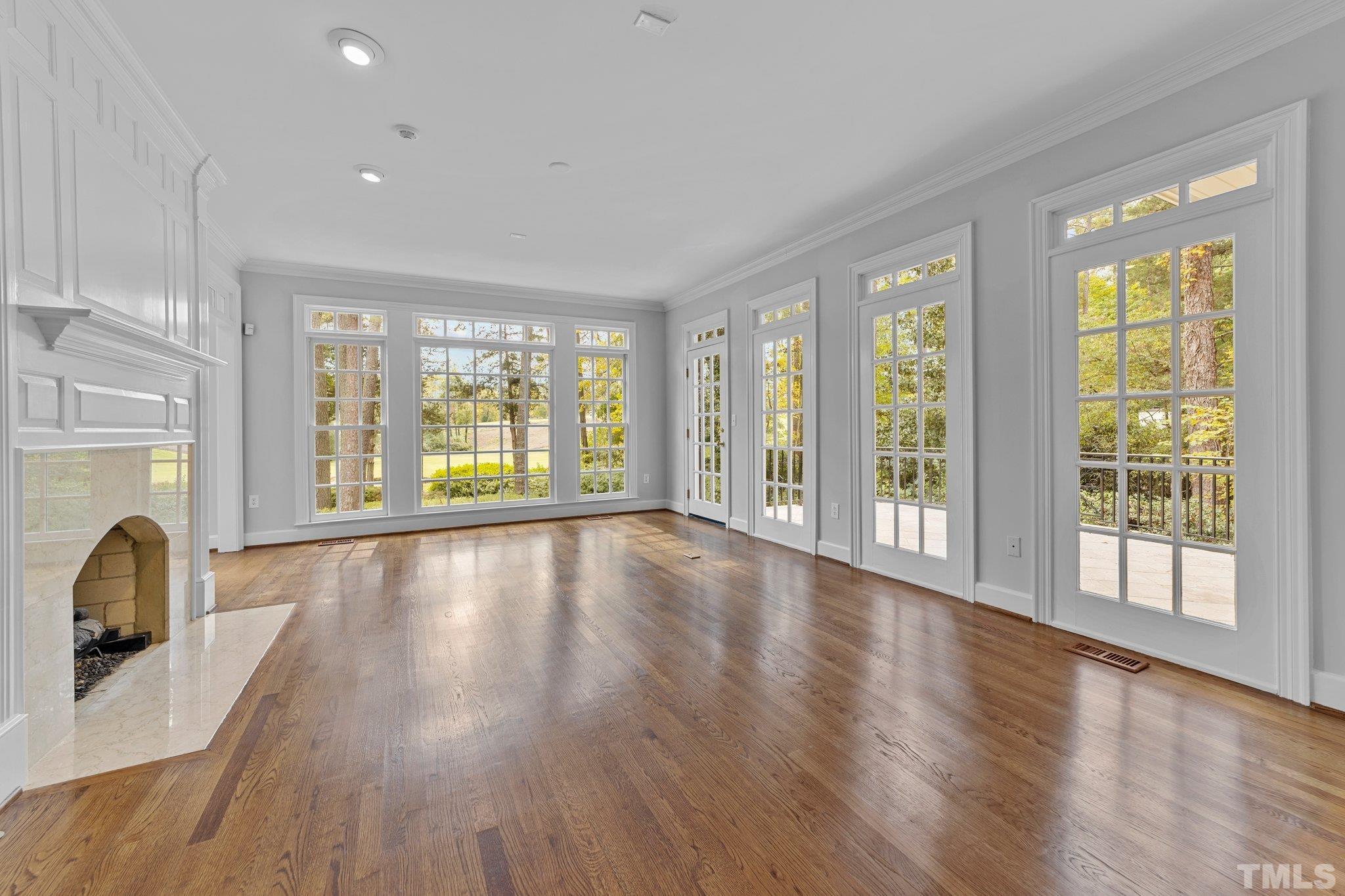 Gleaming oak floors, a very lovely marble fireplace and beautiful vistas make this everyone's favorite room.