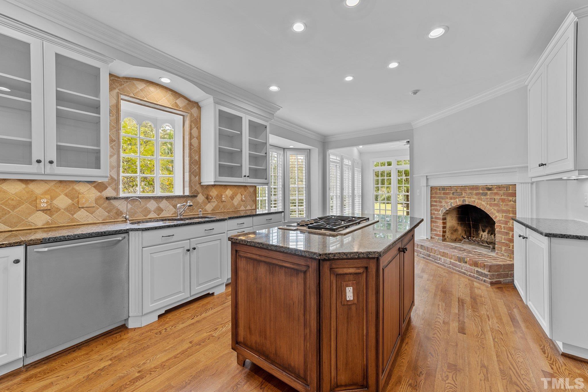 Well appointed Kitchen with fireplace, center island and breakfast alcove.