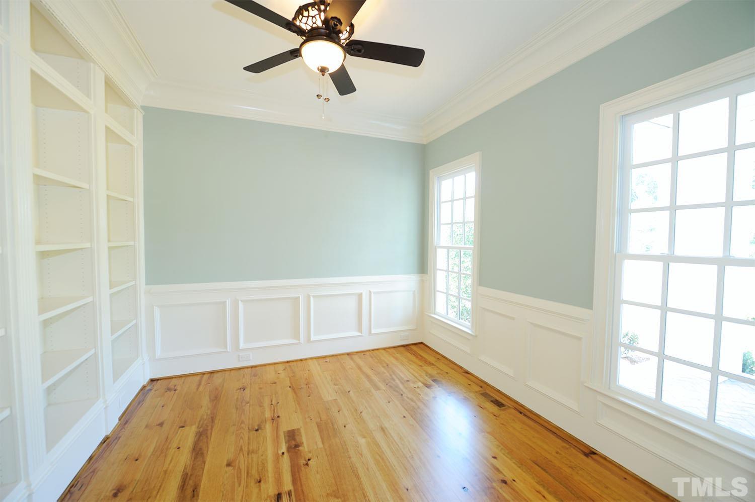 Located off of the foyer and has custom wood bookshelves, wainscoting and heavy crown molding.