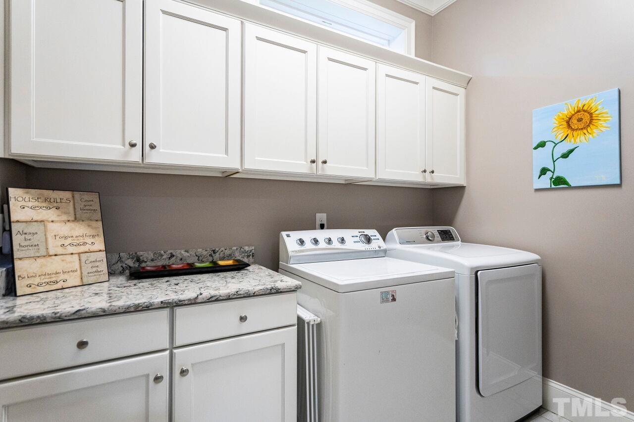 Laundry Room with base/wall cabinets, granite tops, laundry chute and tile floors.