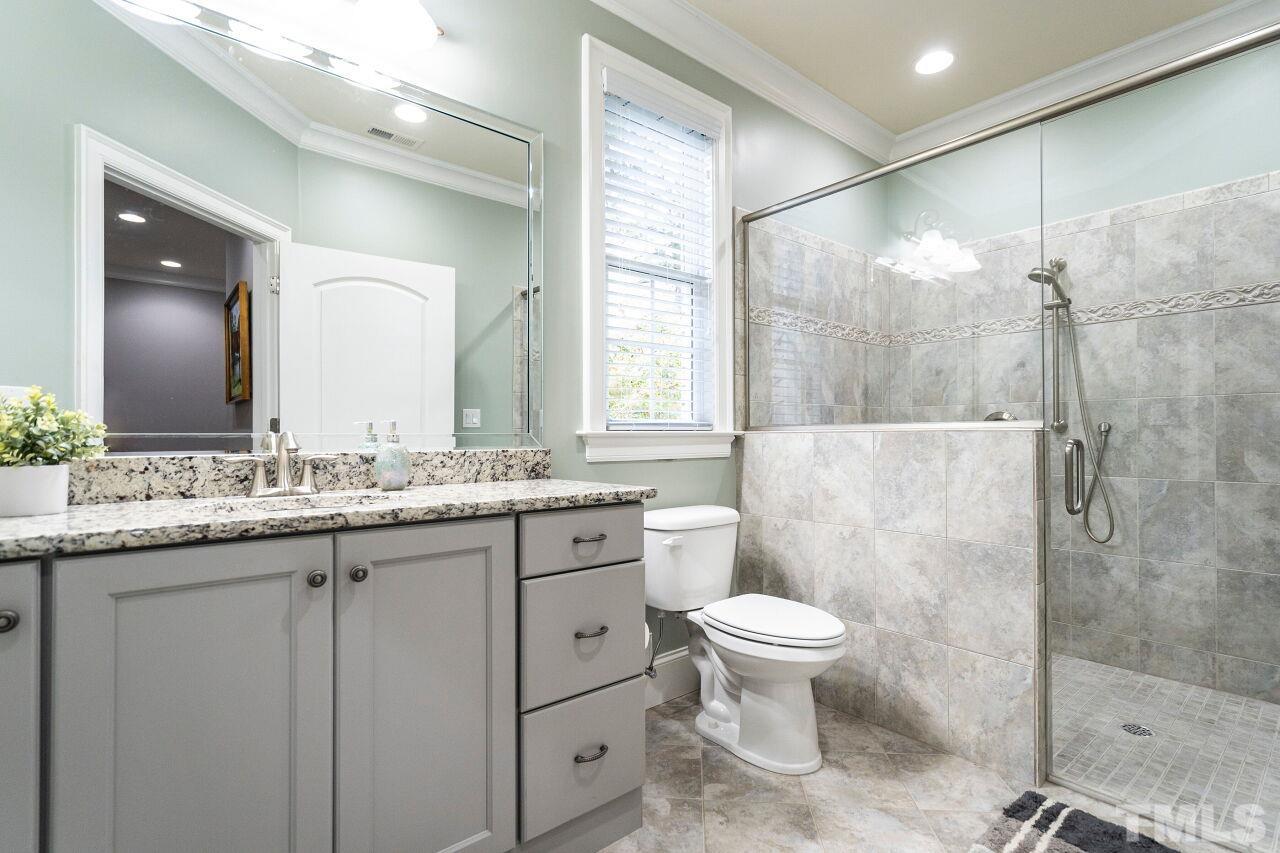 Hall Bathroom 5: Raised painted cabinet vanity, granite top, walk-in no curb shower with glass door and tile floors.