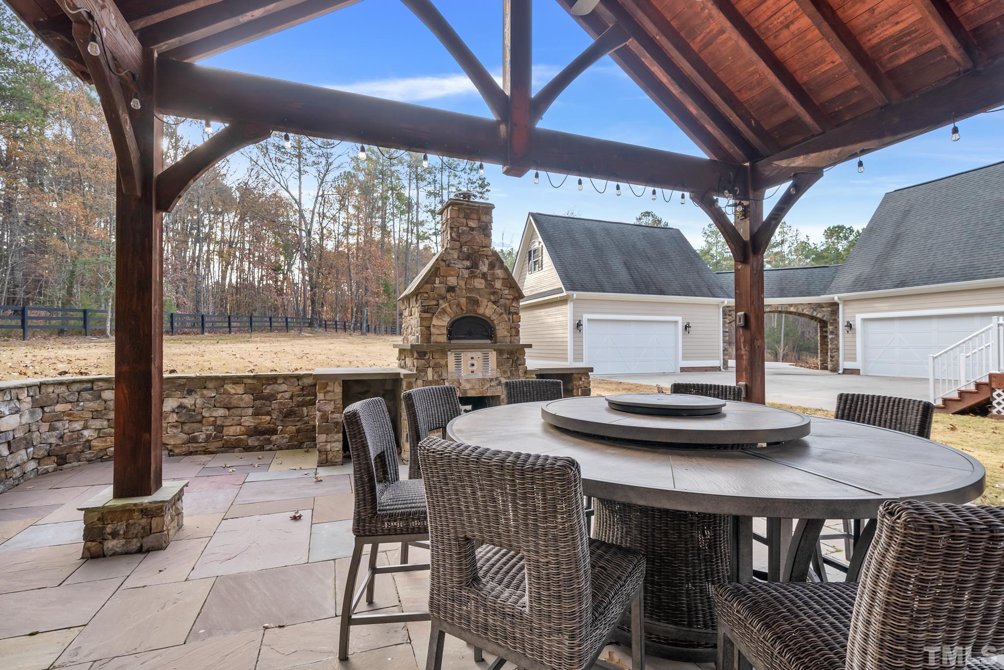 Fire pit consists of a bed of sand and firebrick, with a water drain designed to drain any water so no ash will spill onto the patio.   Brick walls around patio were built the right height to accommodate seating for guests