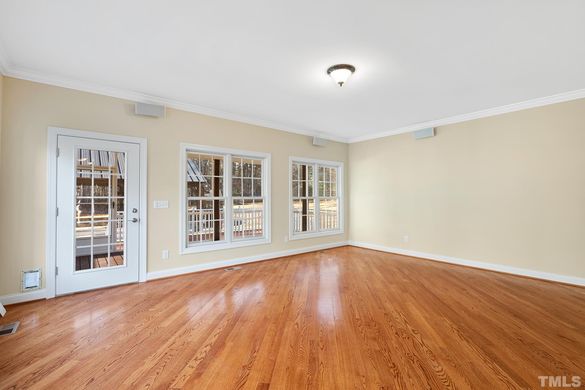 Wonderful large room adjoining kitchen area with door to screened porch and wall of windows.