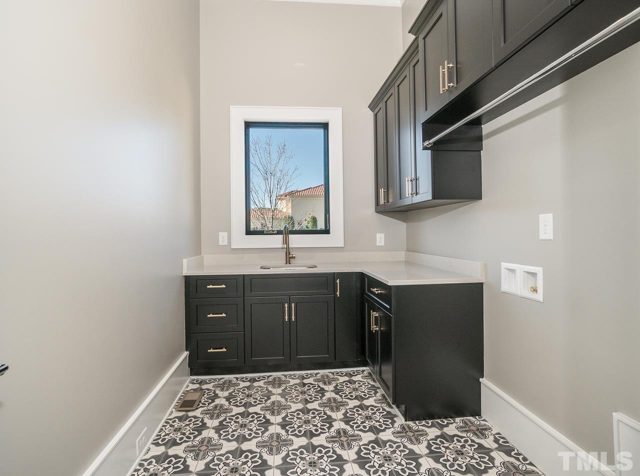 Laundry Room with Tile Floor and Custom Cabinetry