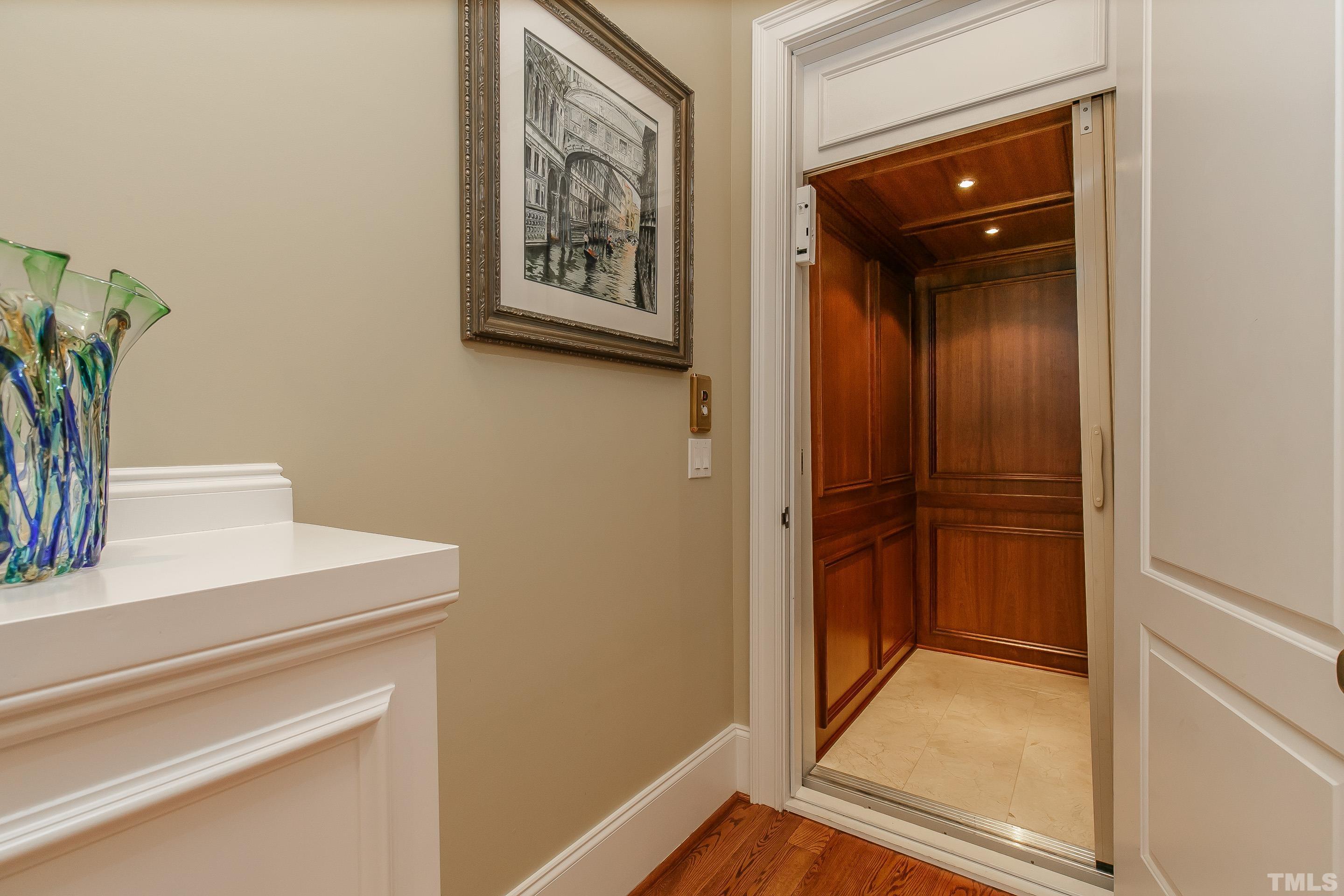 Elevator with mahogany and recessed lights make this home easily accessible