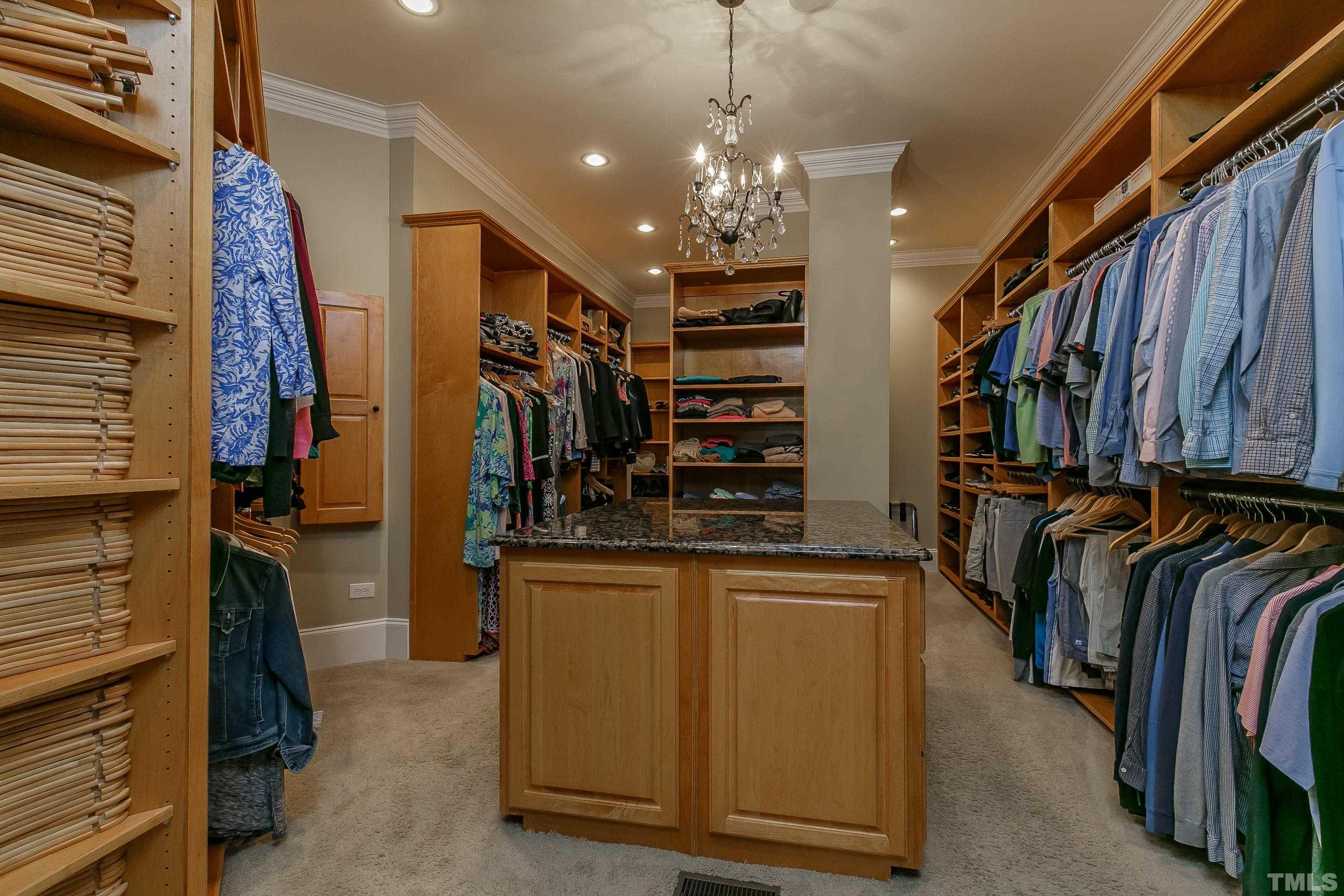 ONE of a KIND custom closet with wood organizers: granite closet island, shoe rack, shelves and built-in ironing board