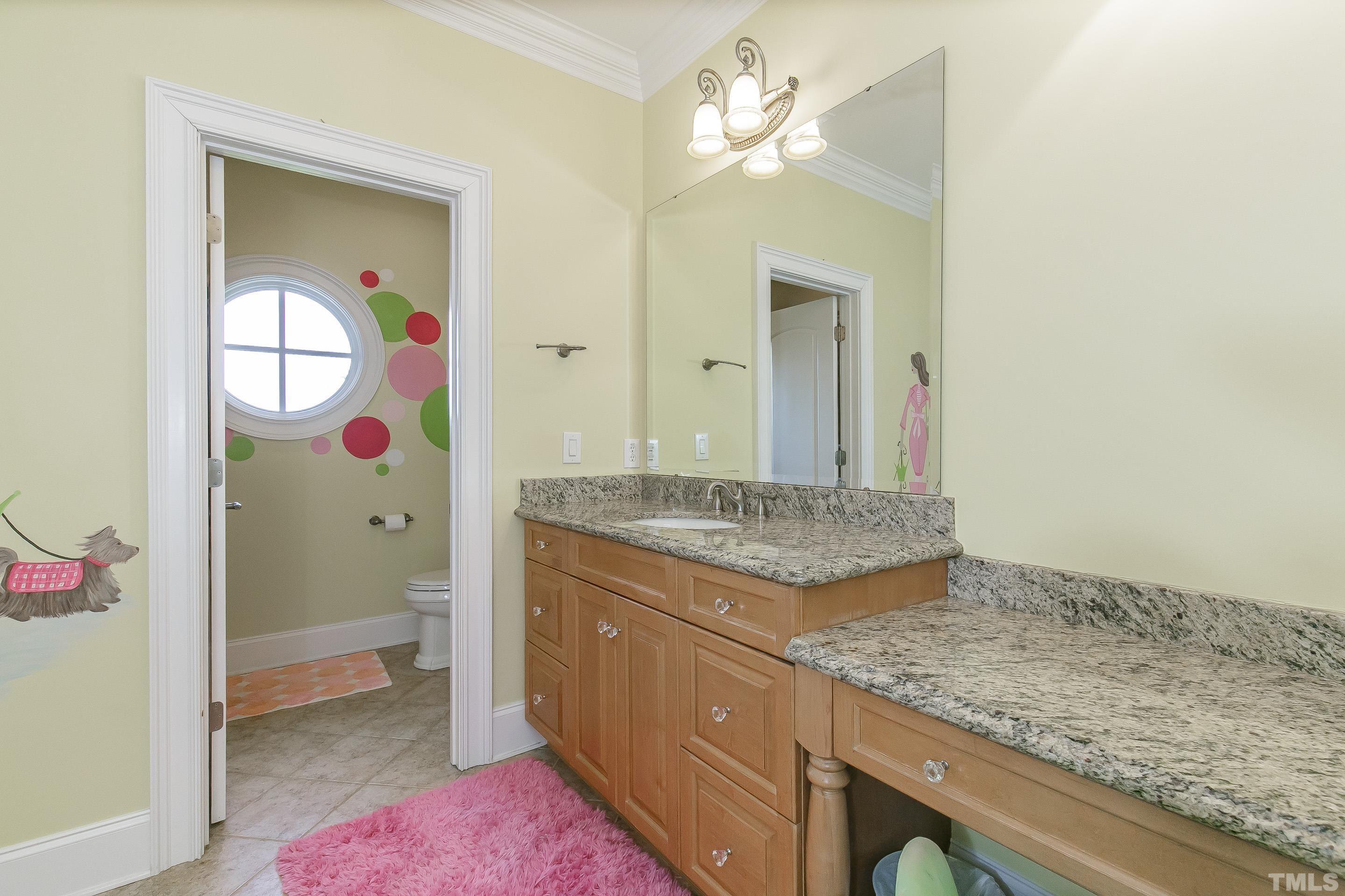 LOVELY In-suite bath with artists painting, granite sink and makeup vanity
