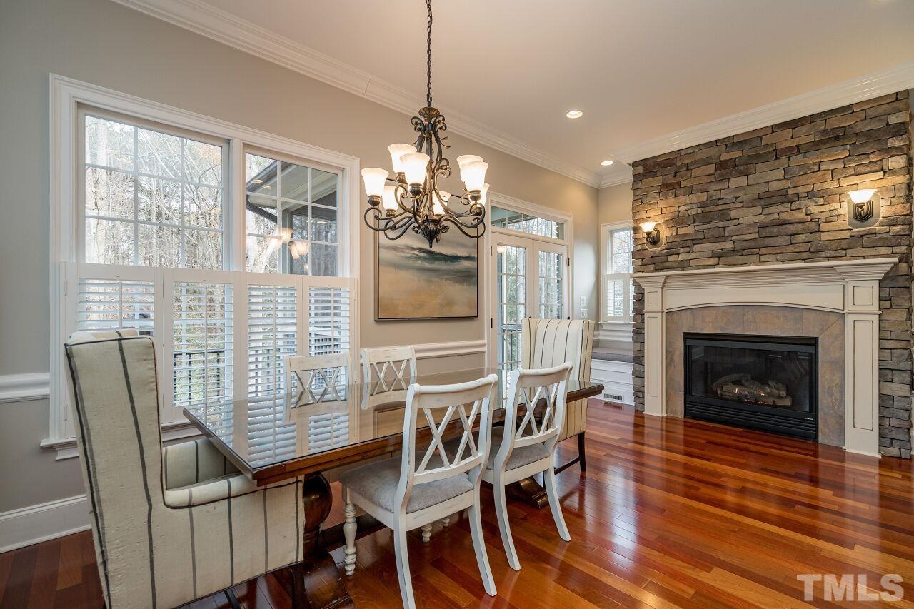 The charming breakfast nook has a beautiful fireplace to enjoy along with built-in seating and a workstation.