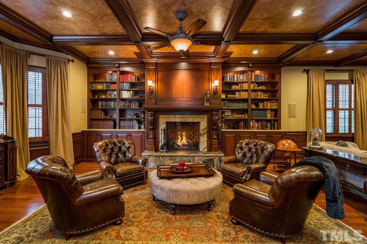 The sunken library has a raised stone hearth with gas log fireplace.  It is one of many focal points in the room.  The space also has a bay window.