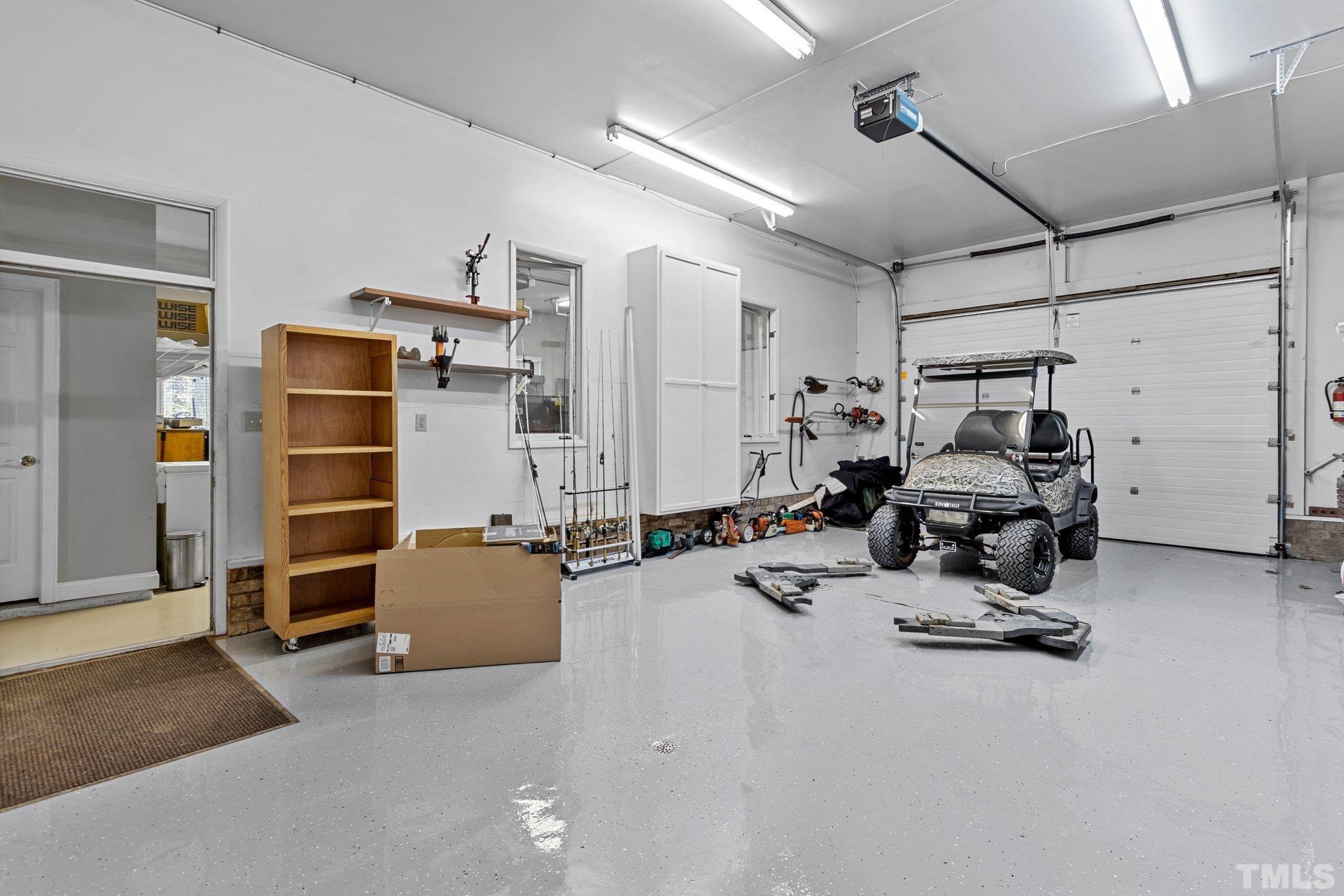 This garage bay has a lift and an air compressor. Tons of storage and cabinets.