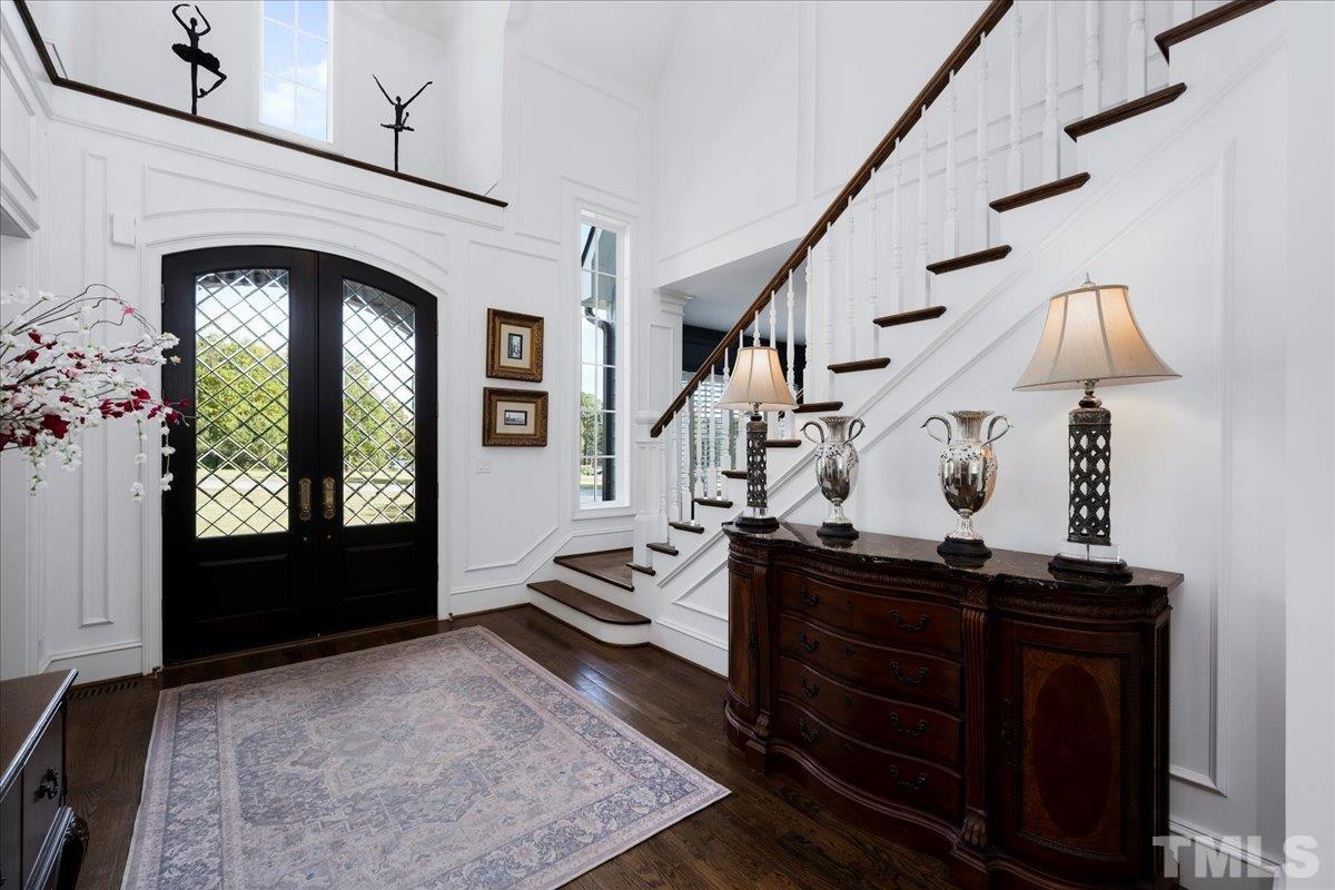 Solid wood, leaded glass double doors with Emtek hardware lead the way to this gorgeous foyer.
