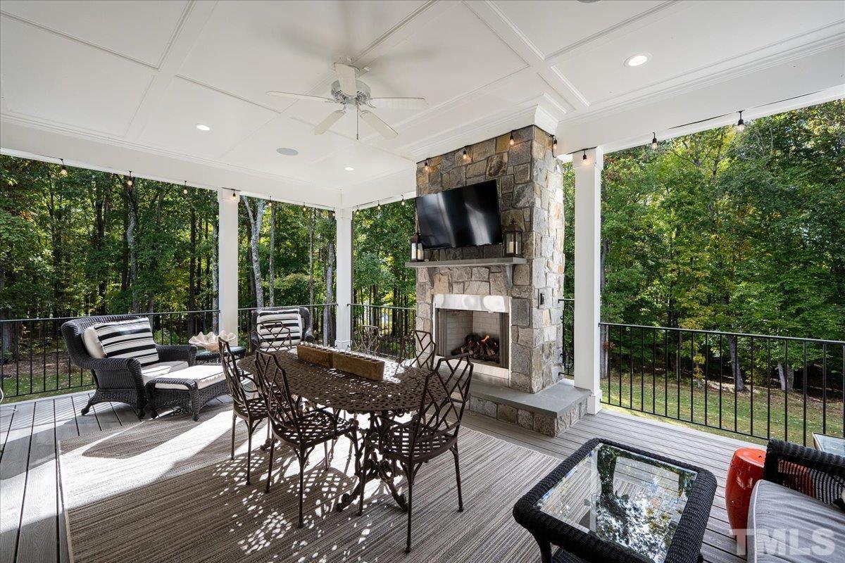 Double doors lead out to this stunning open-air porch with gas fireplace and views of the water, hardwood trees, and private backyard. Sellers often see wildlife.