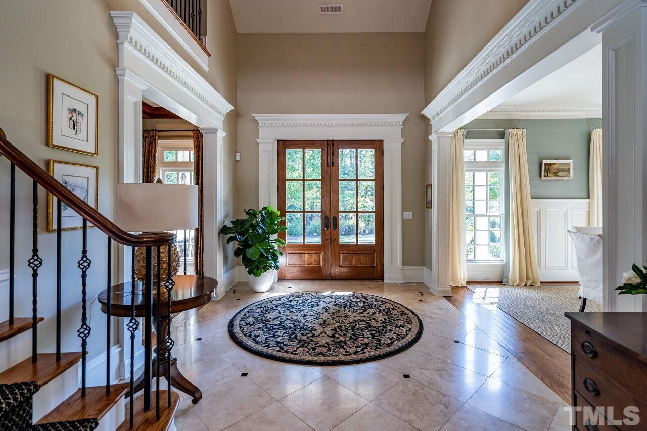 Welcoming foyer sets the tone with a travertine and marble floor, and two story ceiling.