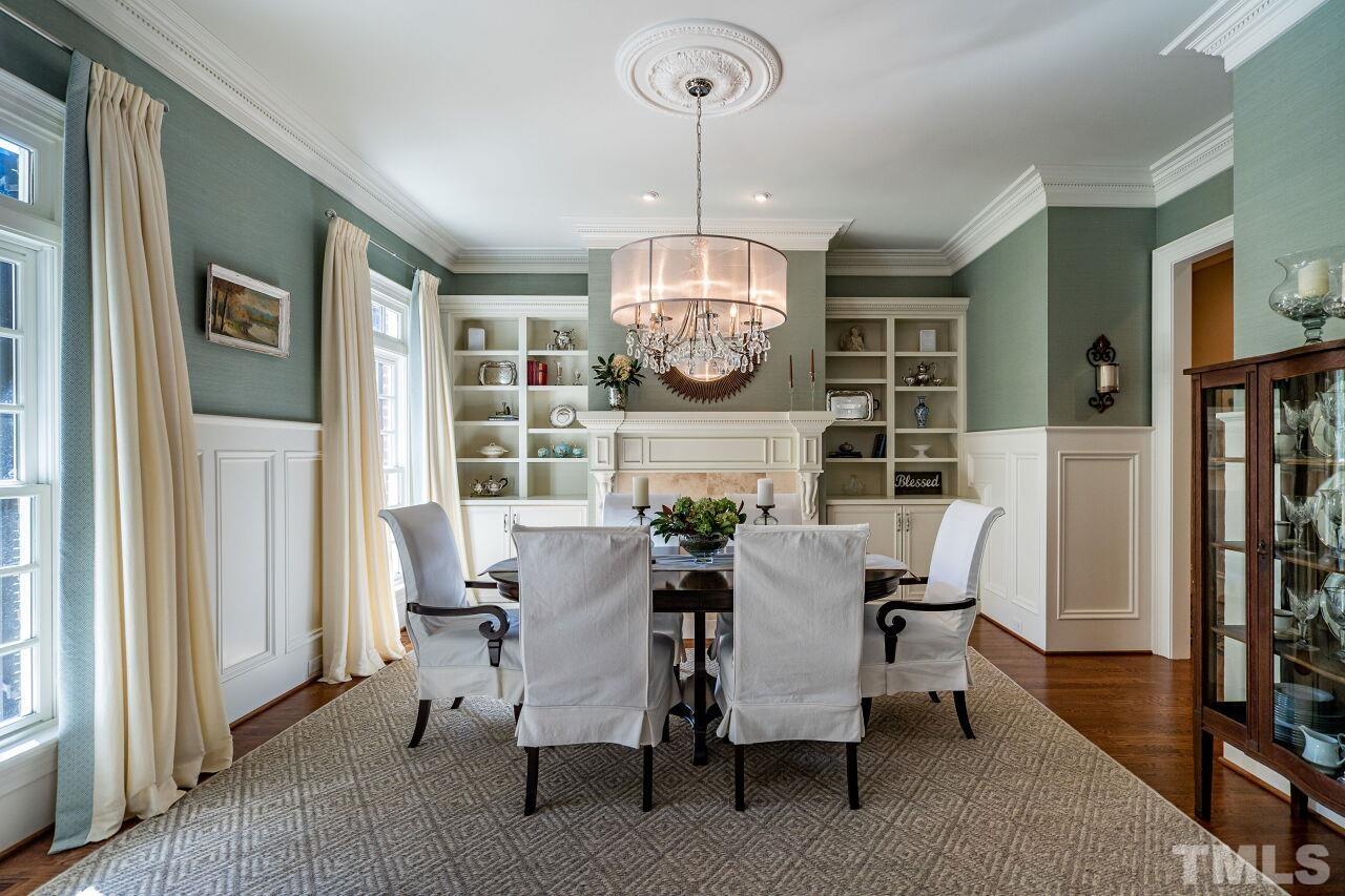 Elegant formal dining with custom, built in shelves and wainscoting.