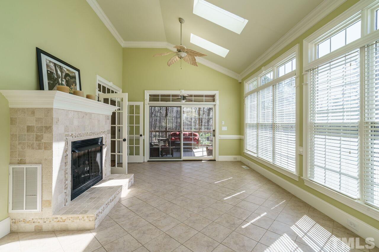 The sun room shares the double-sided fireplace.  Double French doors provide access from the family room.
