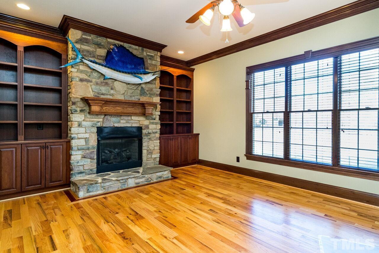 The stacked-stone fireplace adds warmth and charm to this wonderful space.  Use it as a cozy keeping room or home office if desired.  Built-in cabinetry completes the package.
