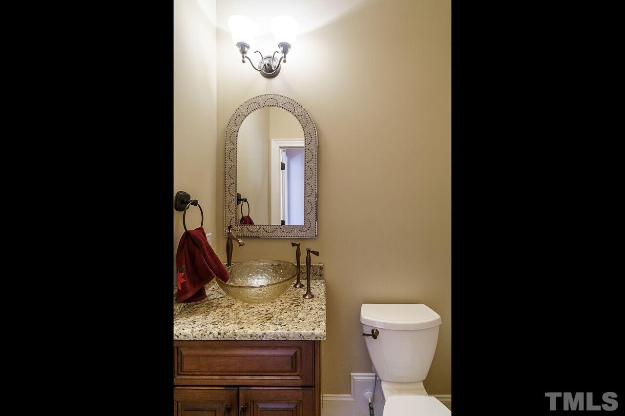 The half bath is found on the first floor and has a beautiful faucet.