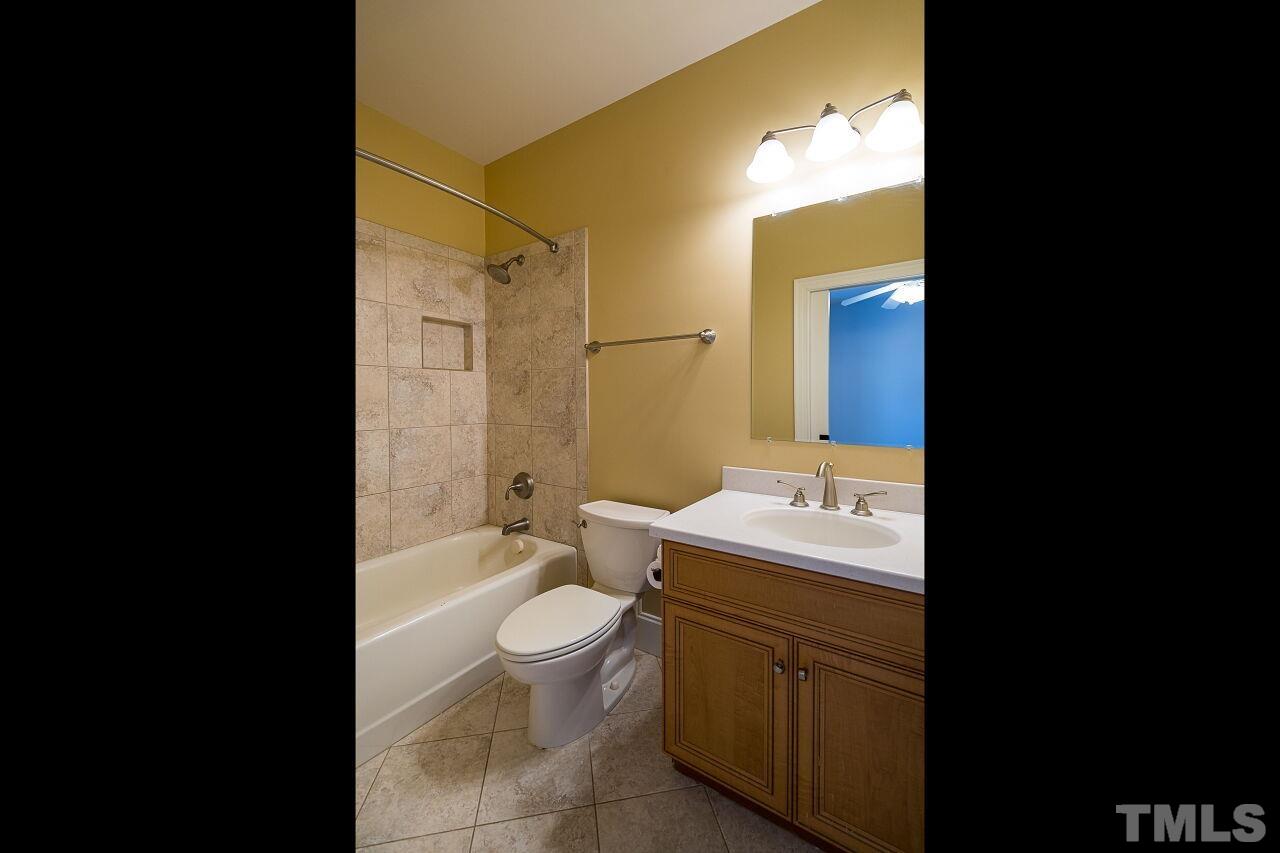 A tub/shower combination is found here with ceramic tile surround.