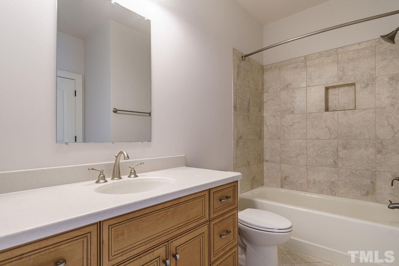 Tile surrounds this tub/shower combination.