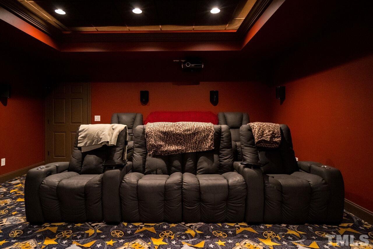 The home theatre has whimsical theatre-themed carpeting and will be the perfect place to spend quality time with your family.