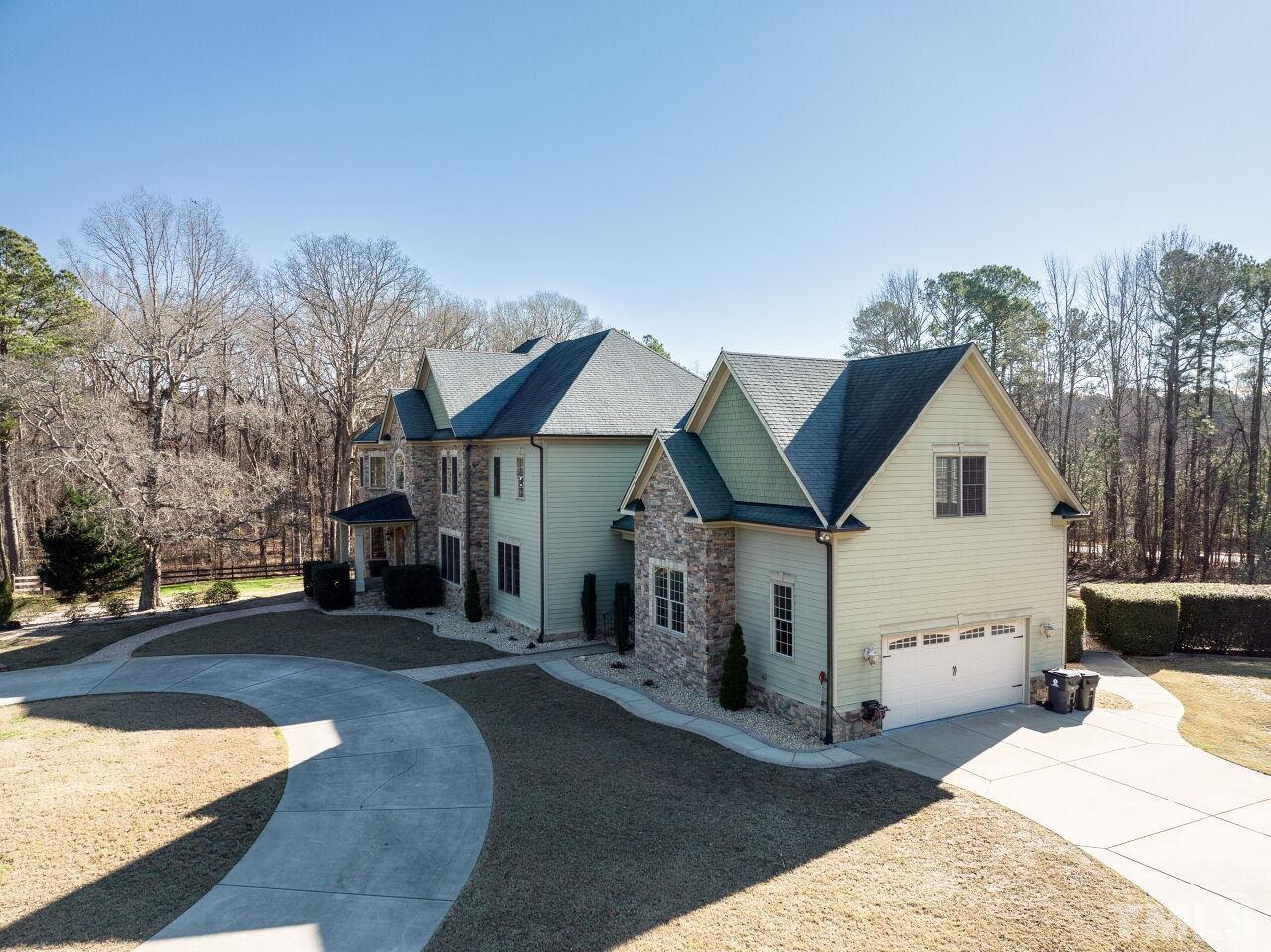 2-car garage, parking pad, circular driveway and a stately entrance - what more could you need?