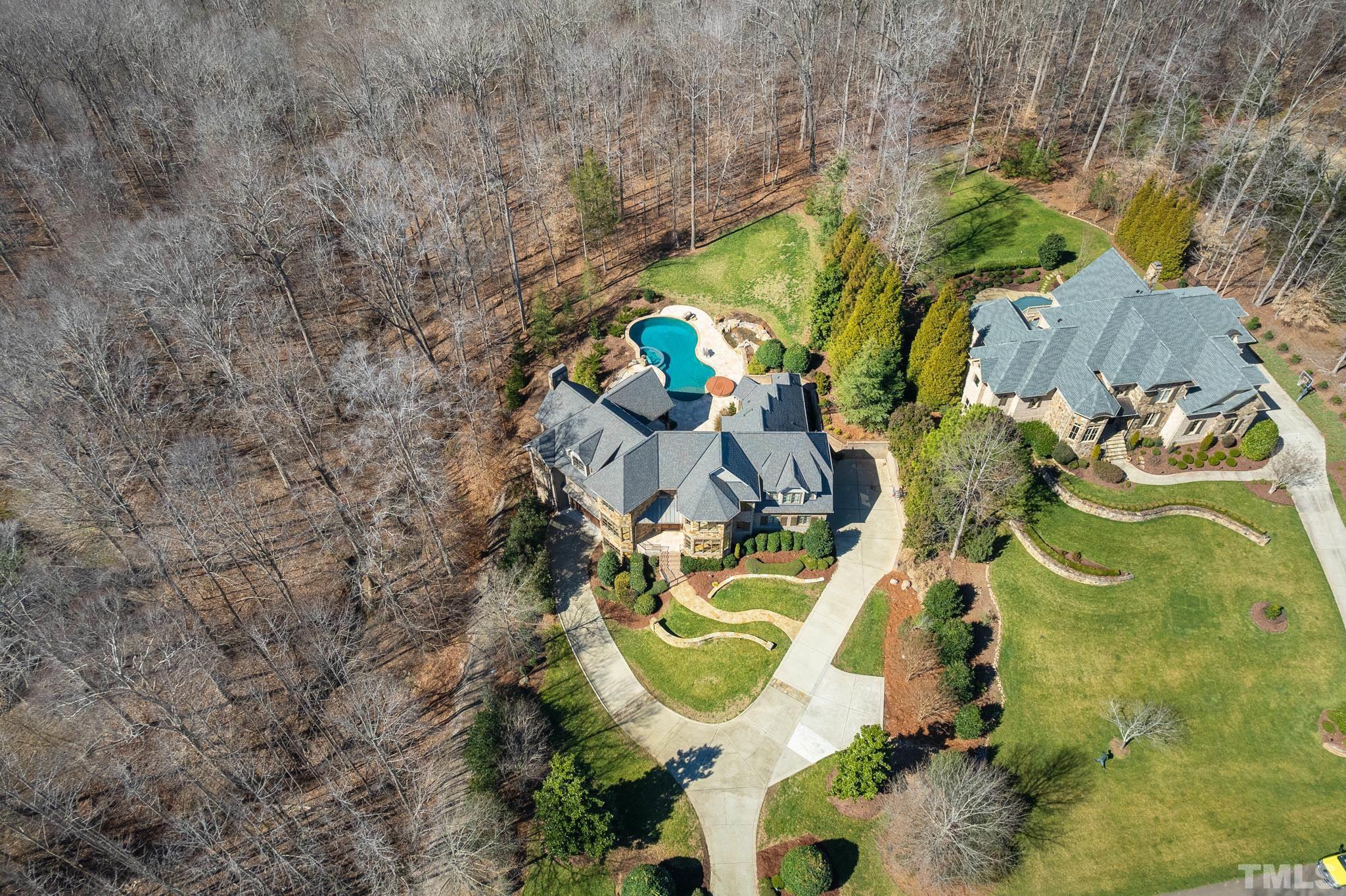 UPDATED! Built for entertaining & multi-generational living features resort-style saltwater pool, spa, outdoor kit, veranda + 5 car garage; Private yard backs onto Falls Lake Preserve -every day???s a staycation. Stunning chef???s kitchen w/Wolf range