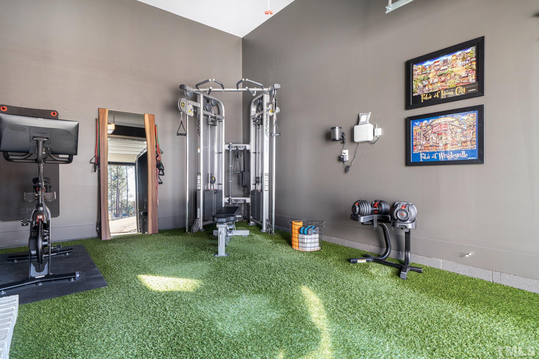 Homeowners have turned the 3rd car garage into a well equipped home gym.