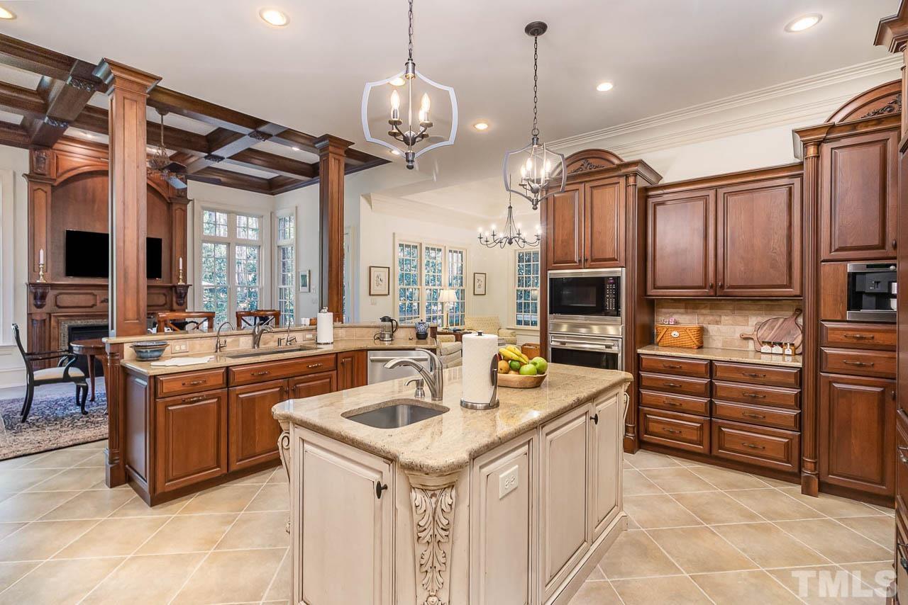 This kitchen has everything you could ask for. Solid cherry wood cabinets, granite counter tops, double wall ovens with a warming drawer, built-in microwave, and a built-in Miele coffee maker to name a few. Also equipped with an oversized sink.