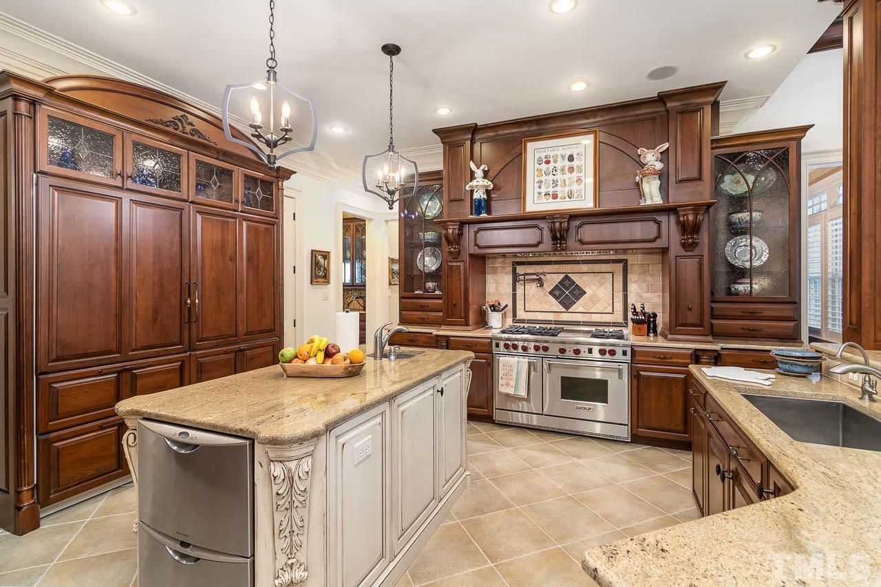 Kitchen offers tons of storage space. As well as two dishwashers, a Wolf stove with a pot filler, two sub-zero refrigerators, and a  built-in mixer lift,