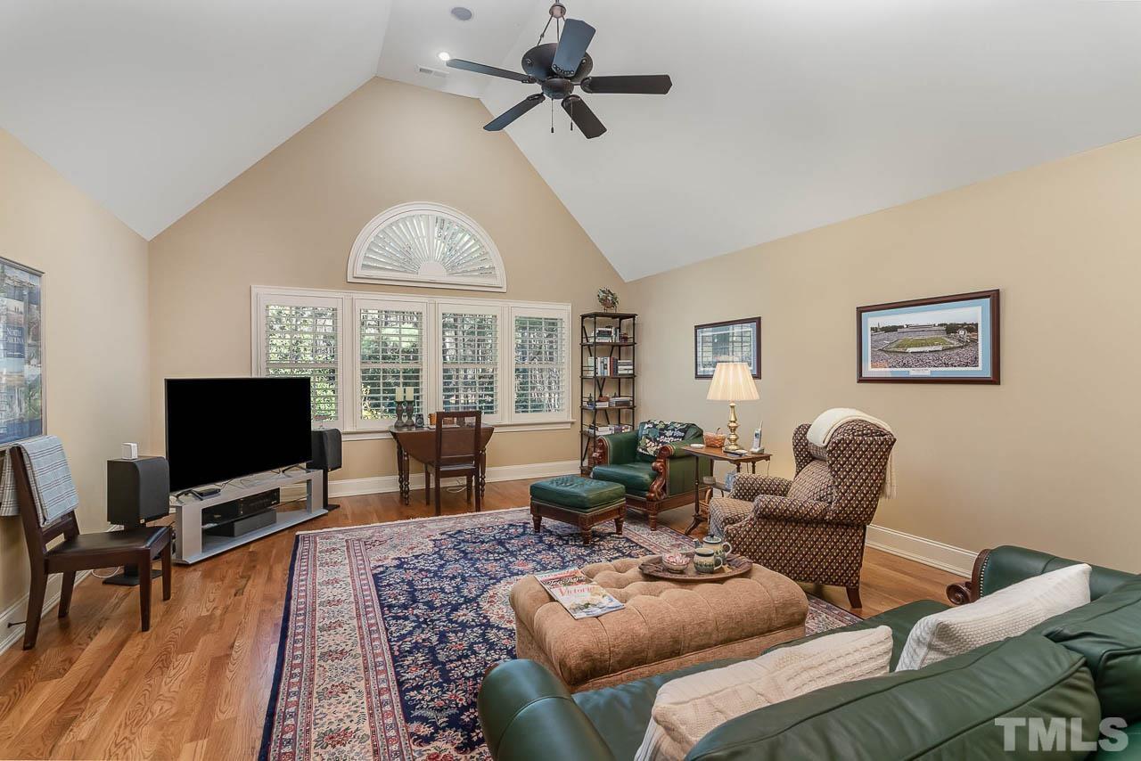 This second floor family room has a vaulted ceiling and plenty of windows to provide natural light and a view of the backyard and pool.