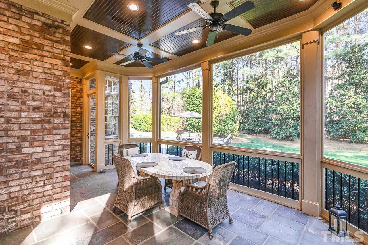 This screened in porch has bluestone tile floor, two ceiling fans, and a perfect view of the backyard.