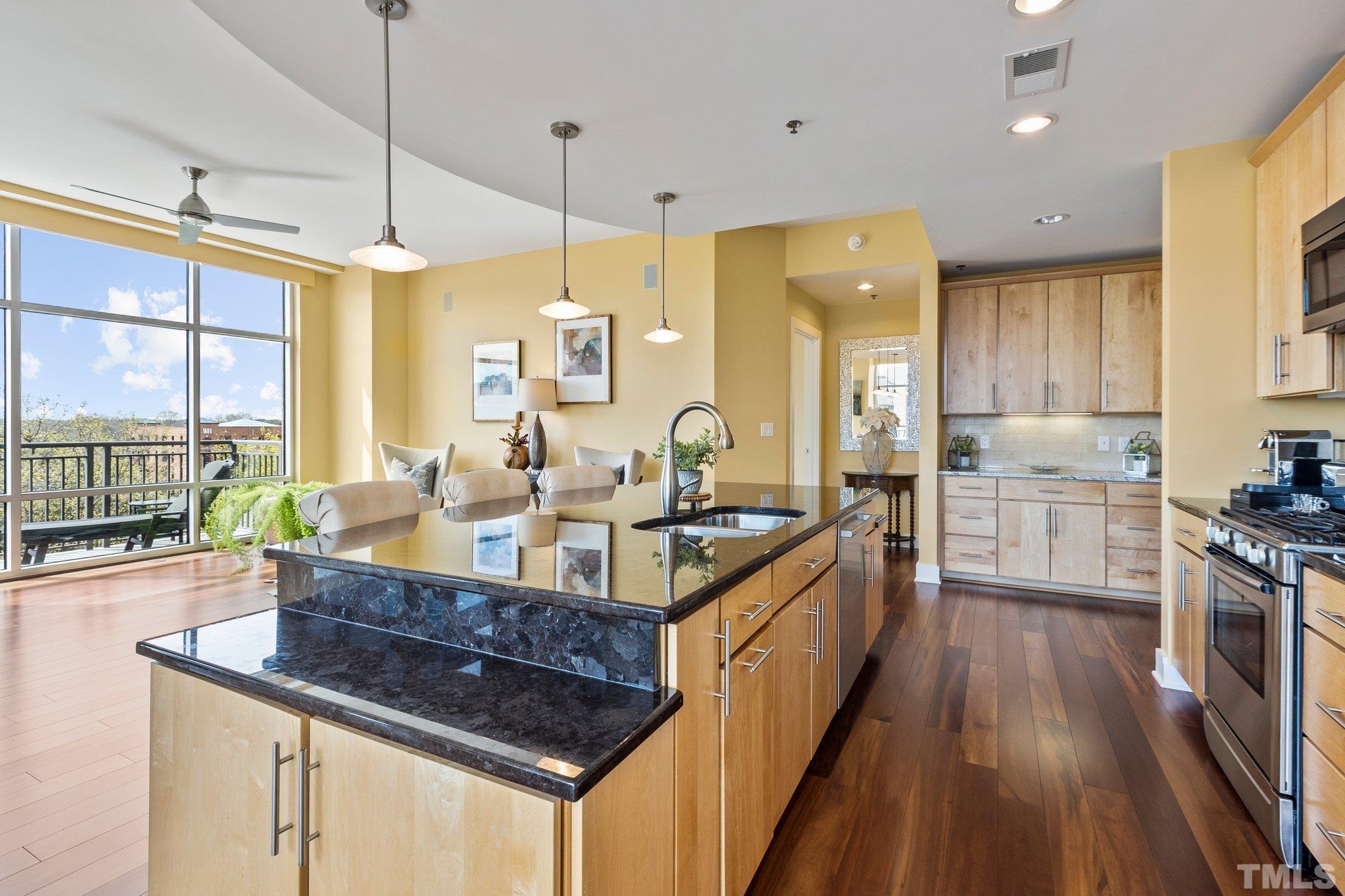 Kitchen has custom cabinetry and granite countertops