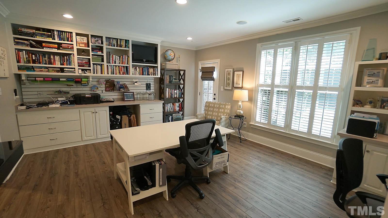 Large office-craft room with tons of windows gorgeous views of backyard.  Built in shelves lots of storage.