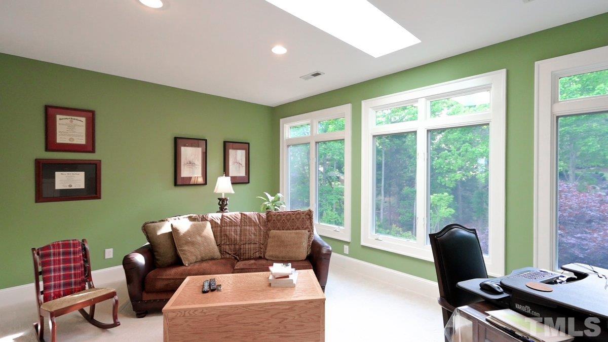 This room has amazing light with new skylight. Utilized currently as office/craft room -  Complimented with BI shelving - access floored storage nook.