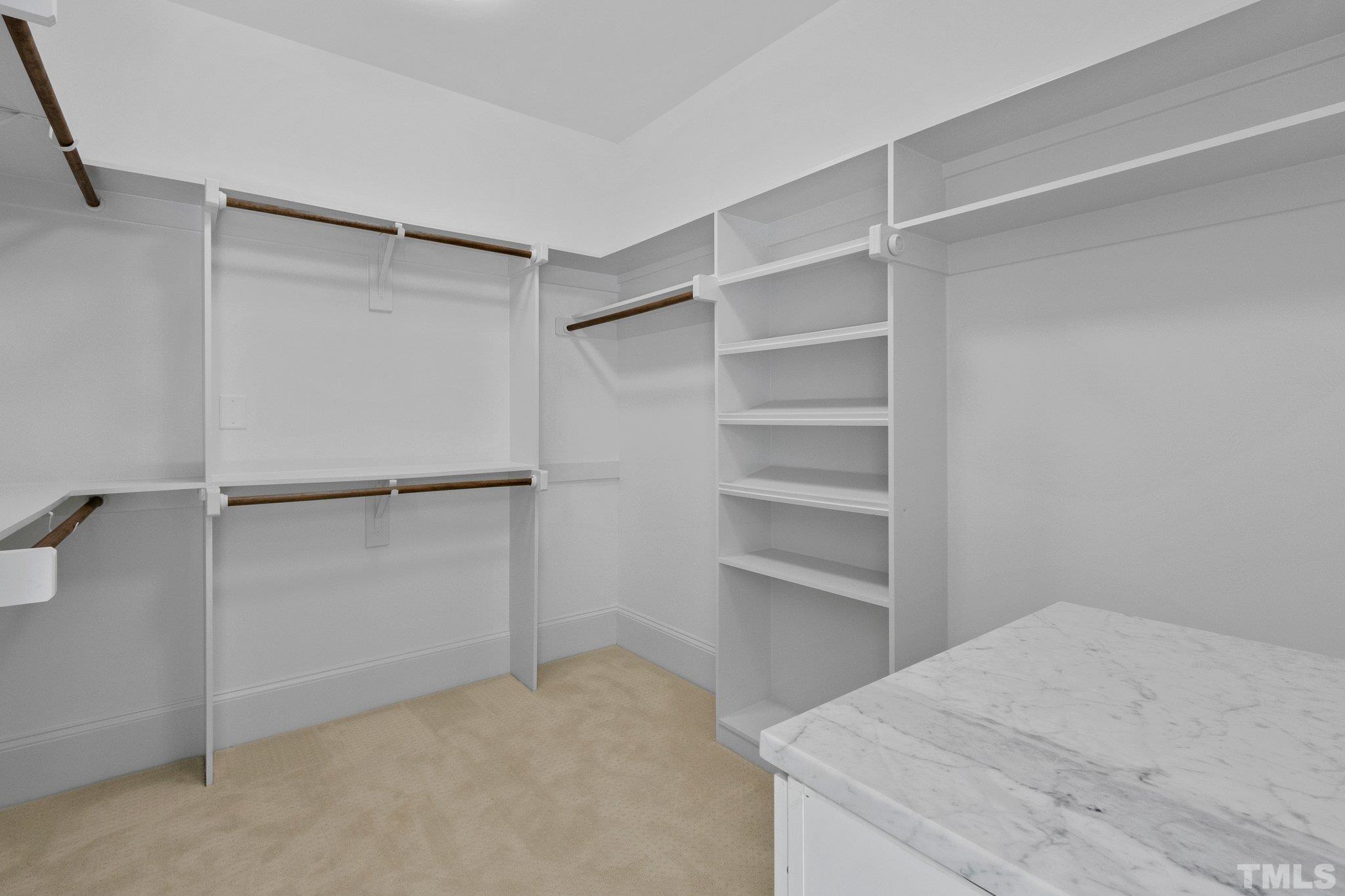 One of two Walk-In Master Bathroom Closets with custom shelving.
