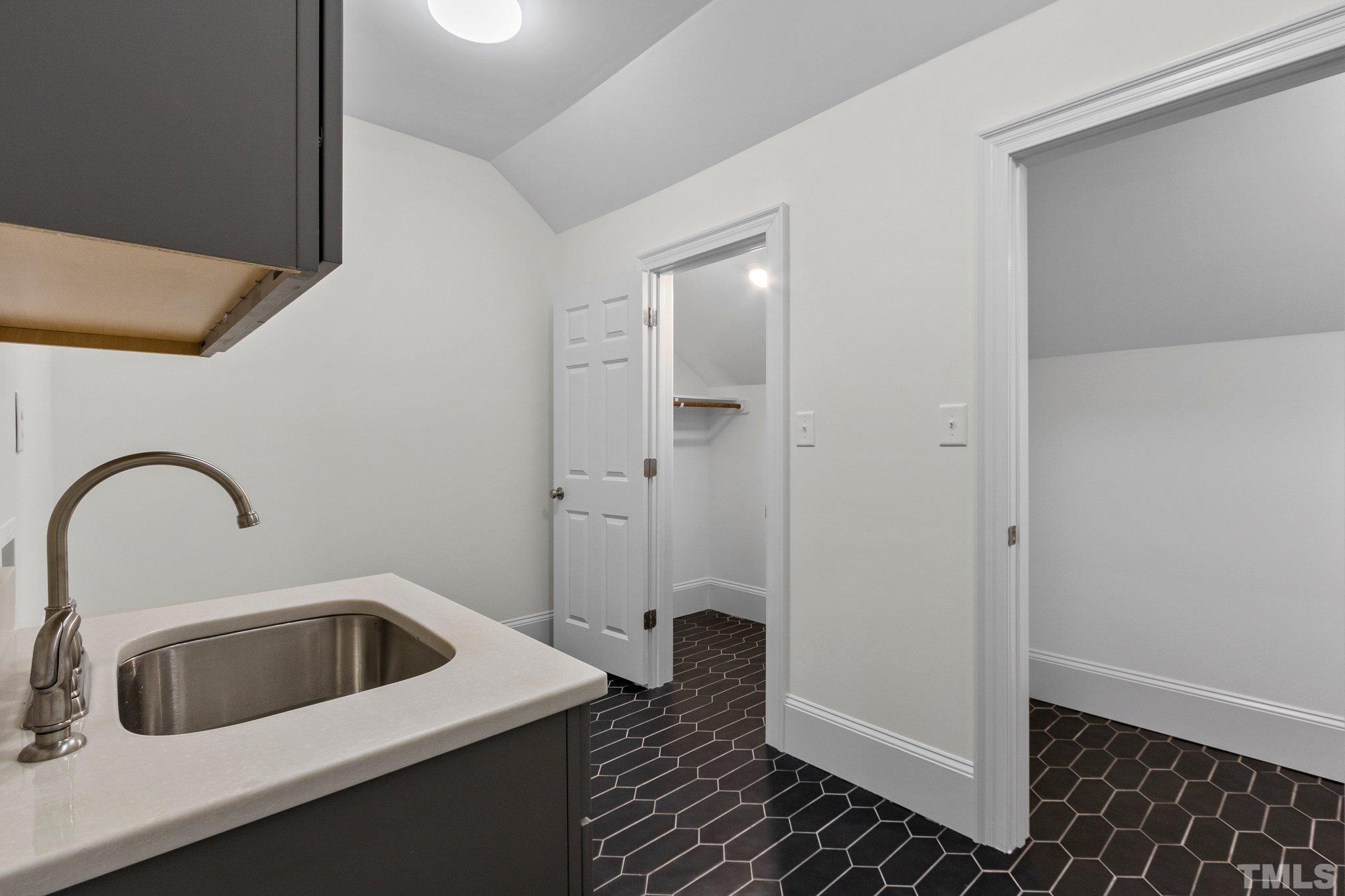 2nd Floor Laundry Room. Features a sink, storage cabinets and storage closets.