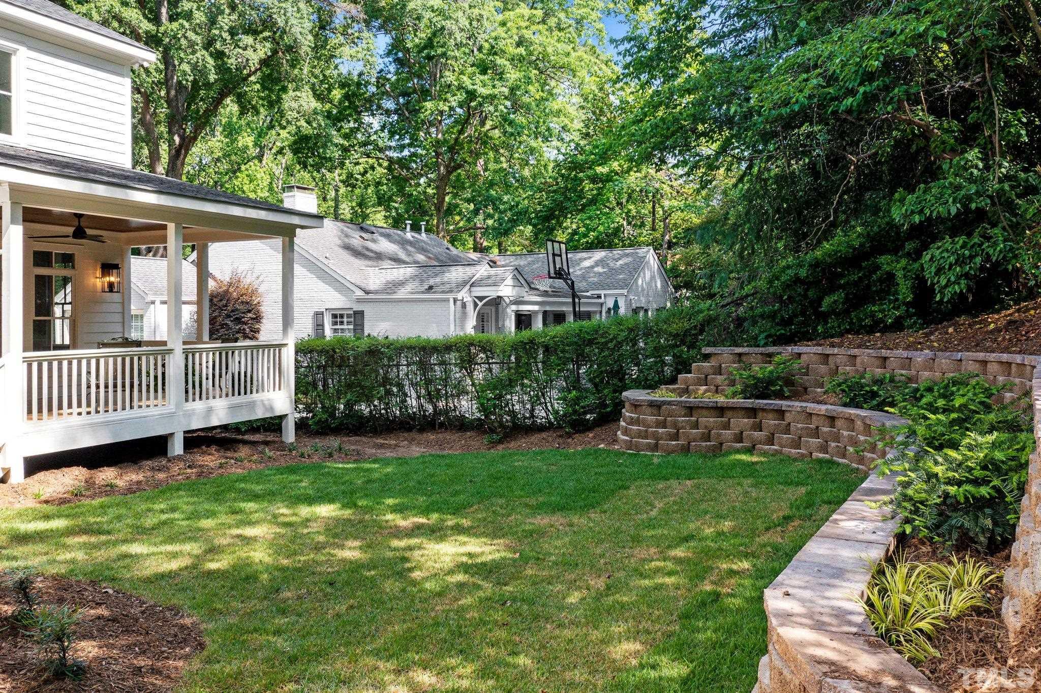 Newly constructed retaining walls create a cozy, semi-private backyard space.