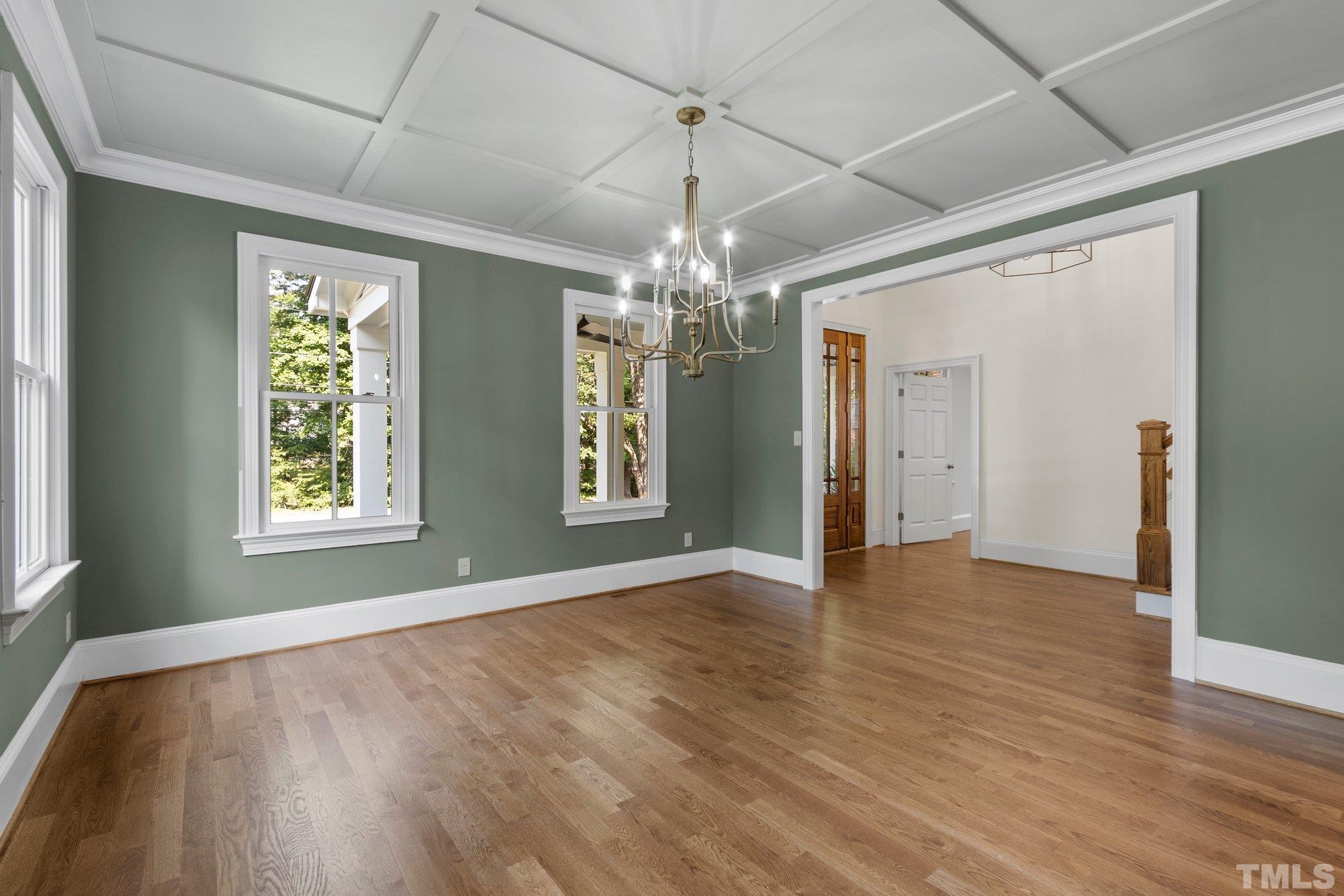 Spacious and bright, coffered ceiling dining room with crown molding throughout!