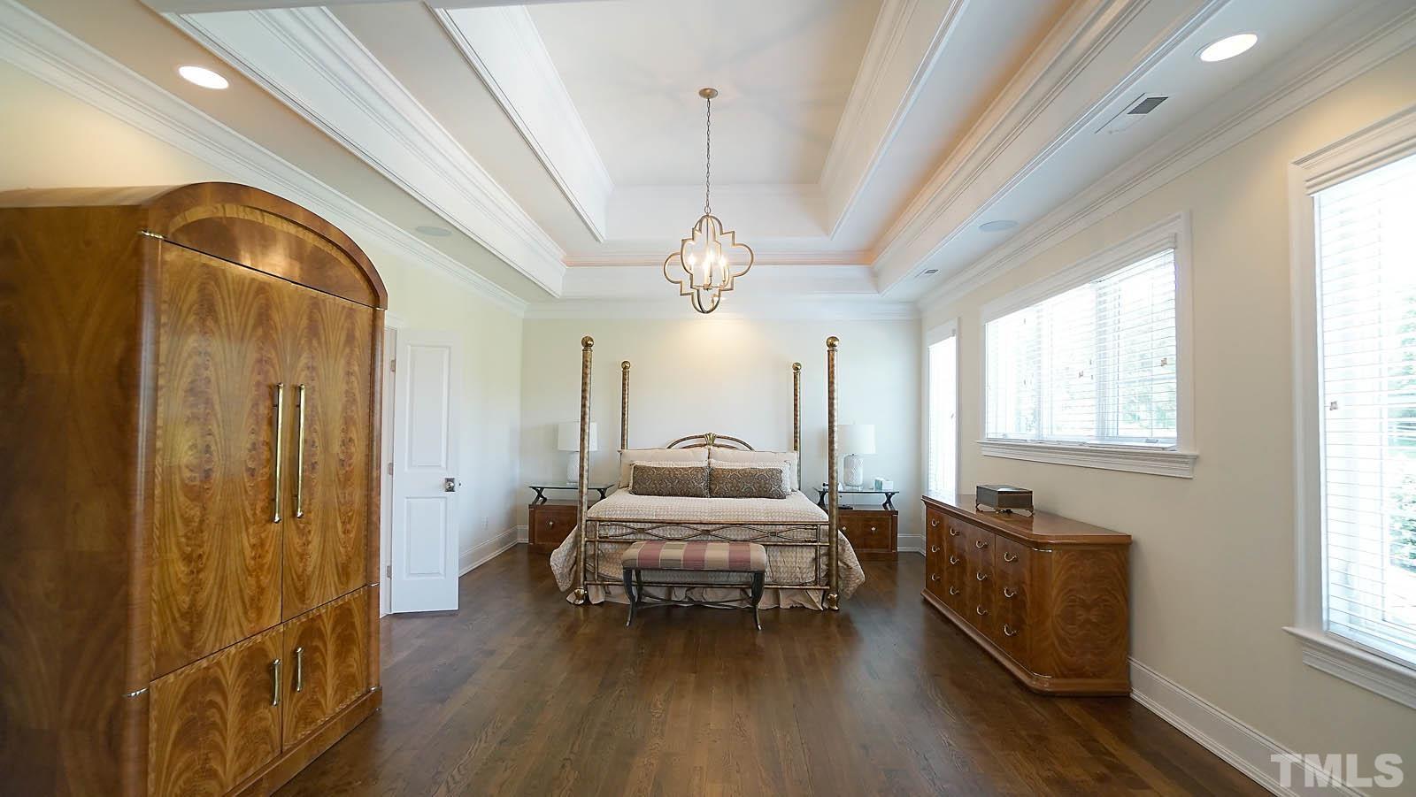 Oversized primary bedroom with sitting area, amazing custom closet with island and Hollywood bath with dual vanities and walk in tiled shower.