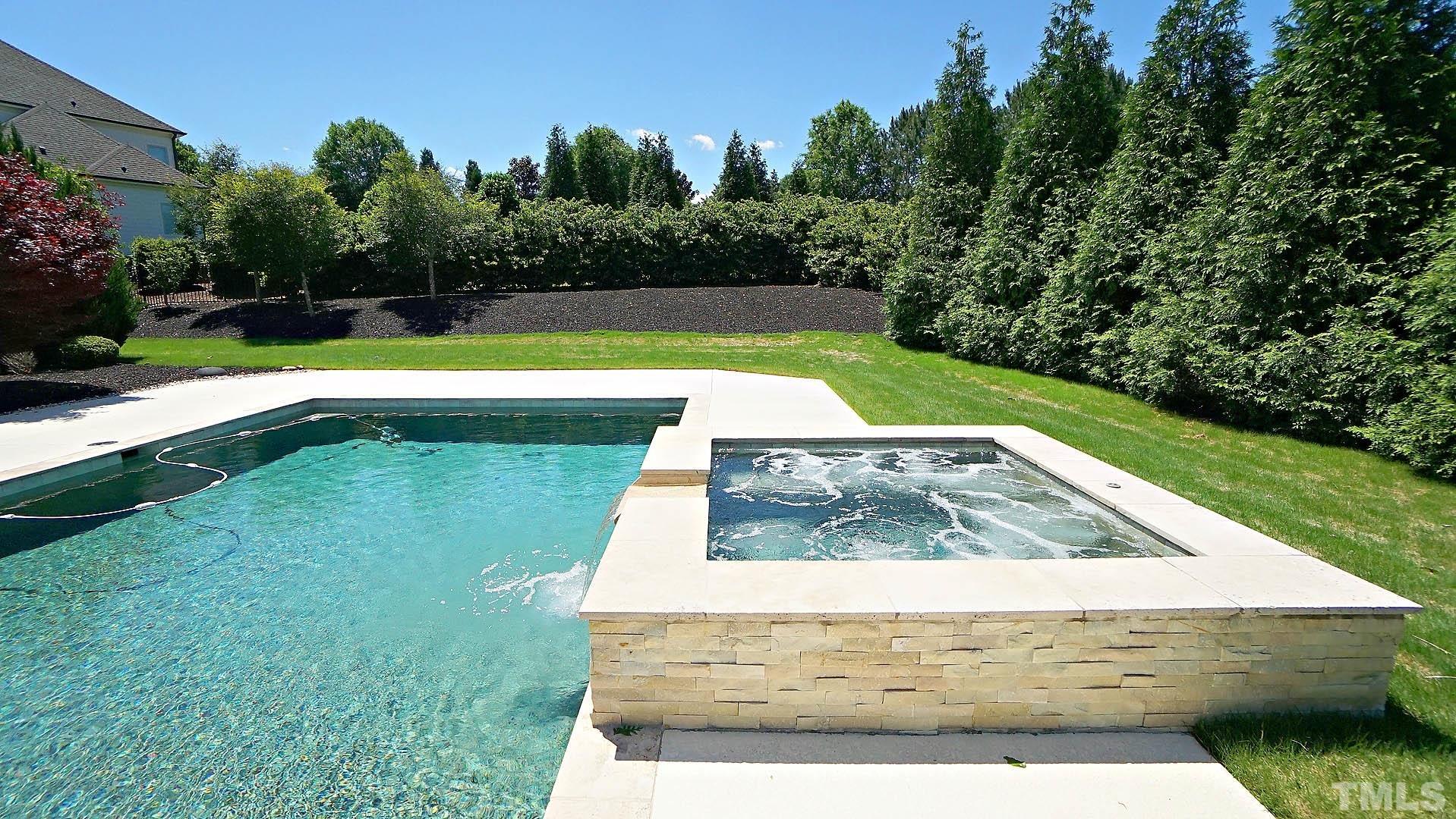 Heated Saltwater Pool with hot tub and fountains.
