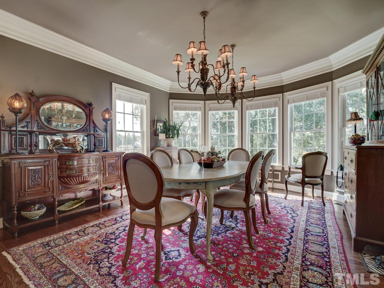 Elegant dining area overlooks the backyard & pond- door leads to the Screened Porch
