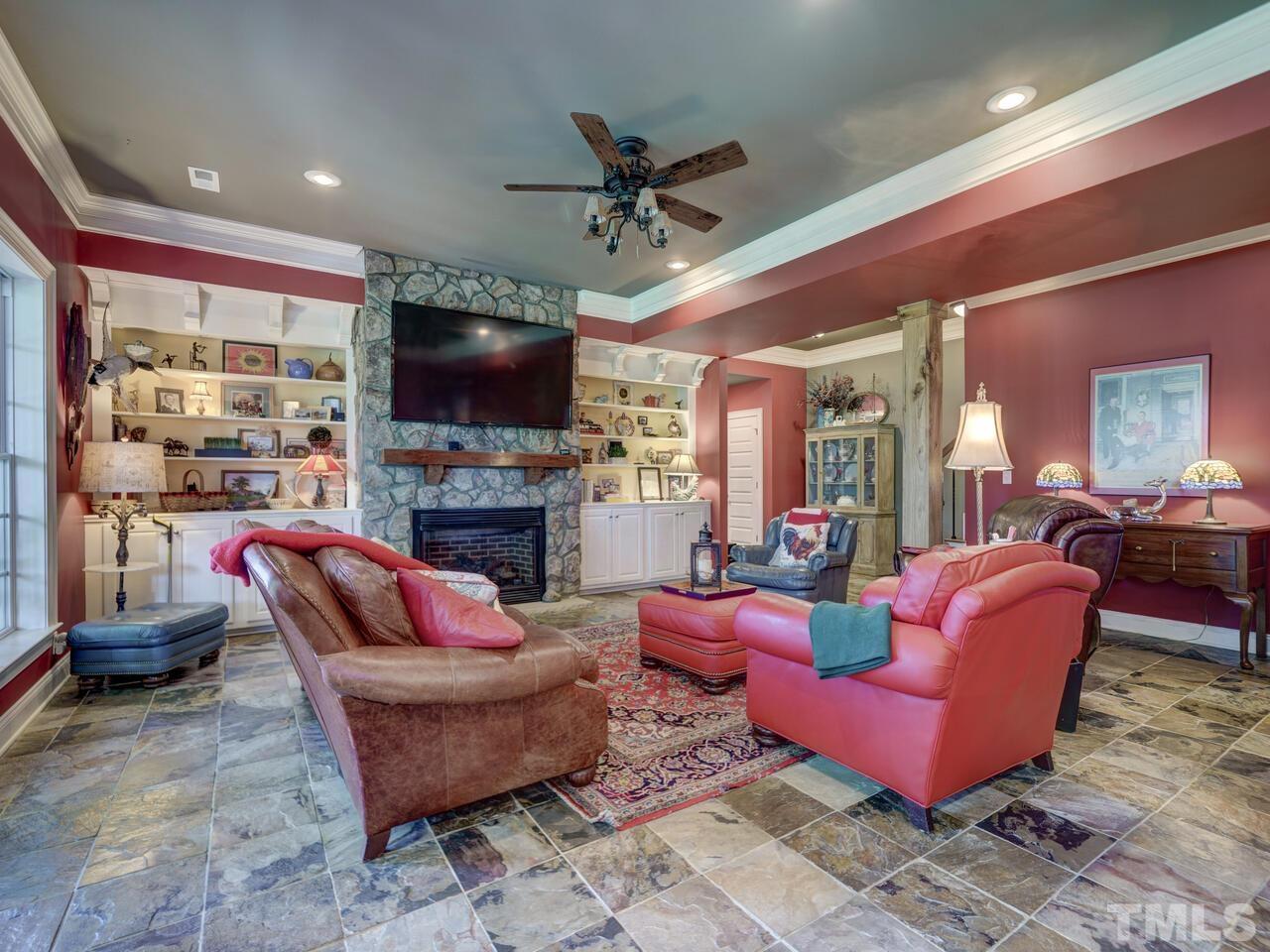 The Lower Level has a spacious Rec Room. There is a Stone Fireplace flanked by Built-In Shelves.