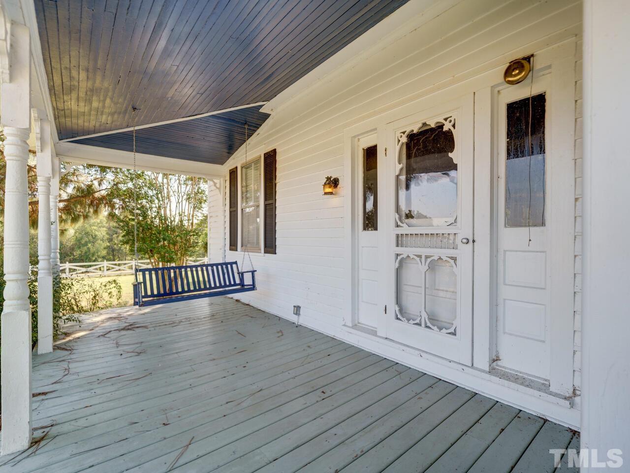 a Rocking chair porch on the Guest Home-perfect place for a lazy Sunday afternoon. Rental potential!